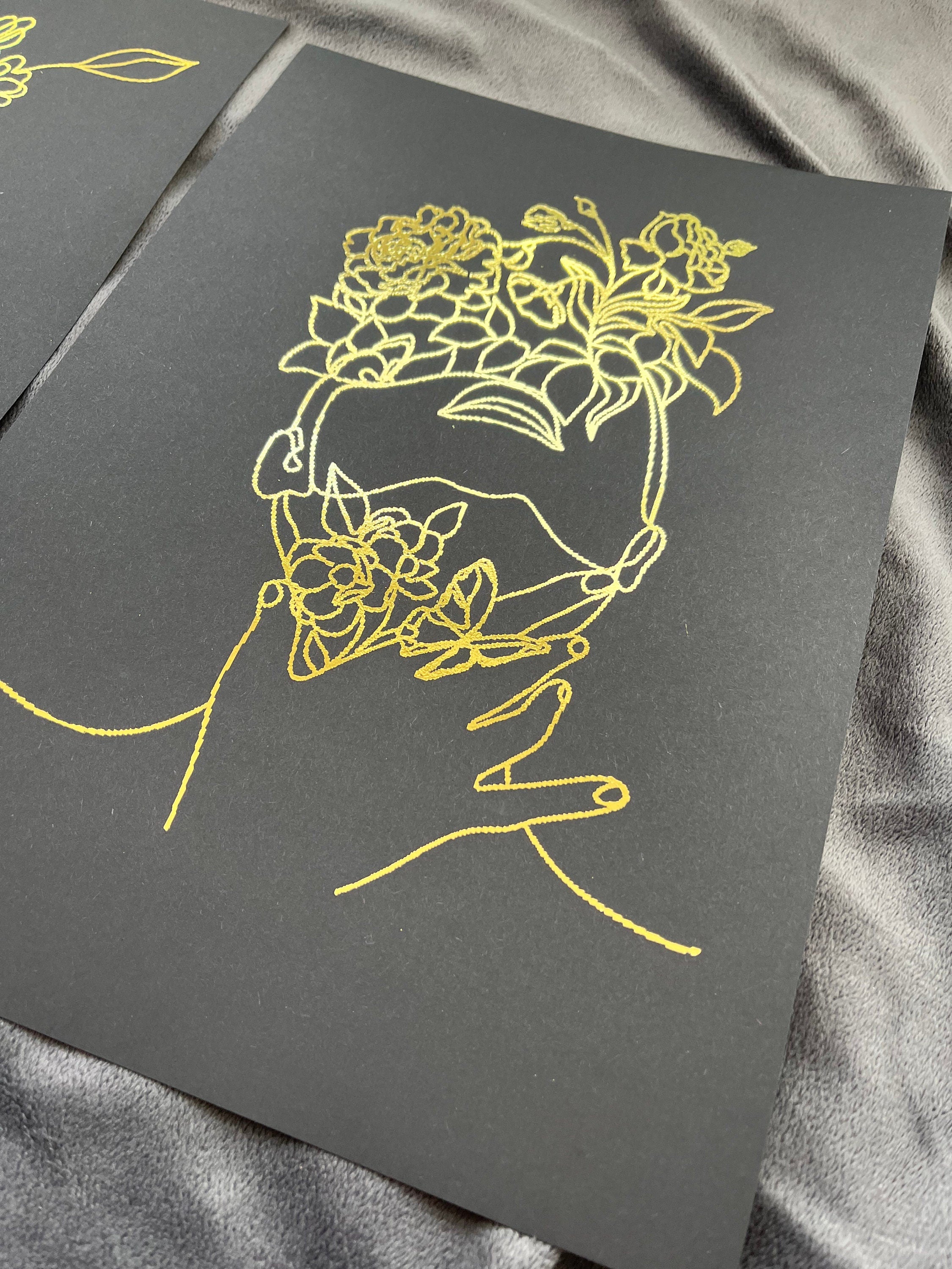 Set of 3 elegant foil prints featuring one line drawings of women's faces in black and gold, showcasing minimalist art style.