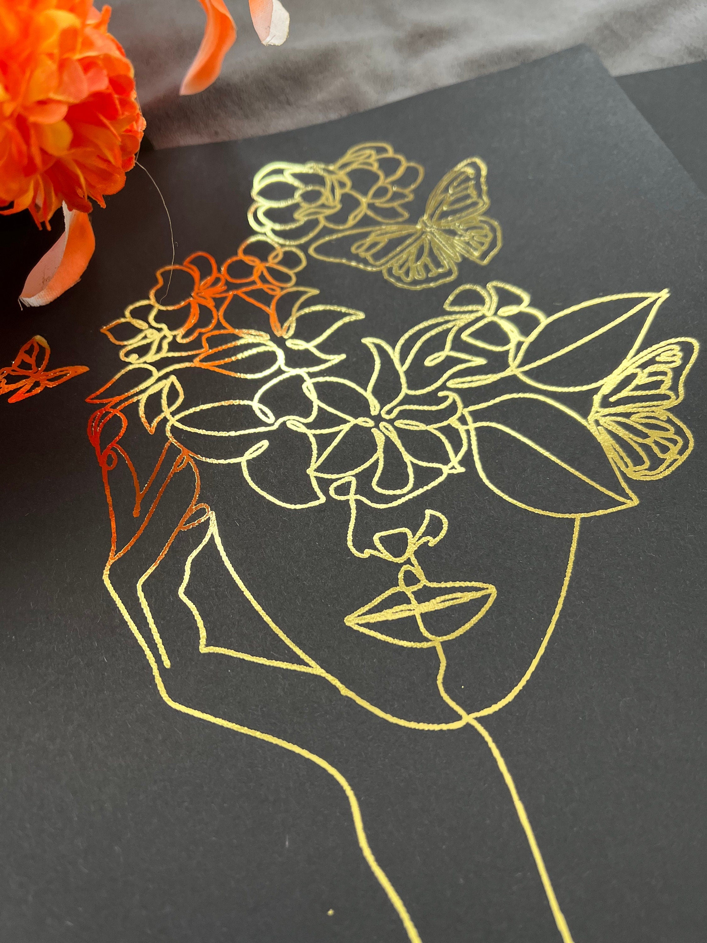 Set of 3 elegant foil prints featuring one line drawings of women's faces in black and gold, showcasing minimalist art style.