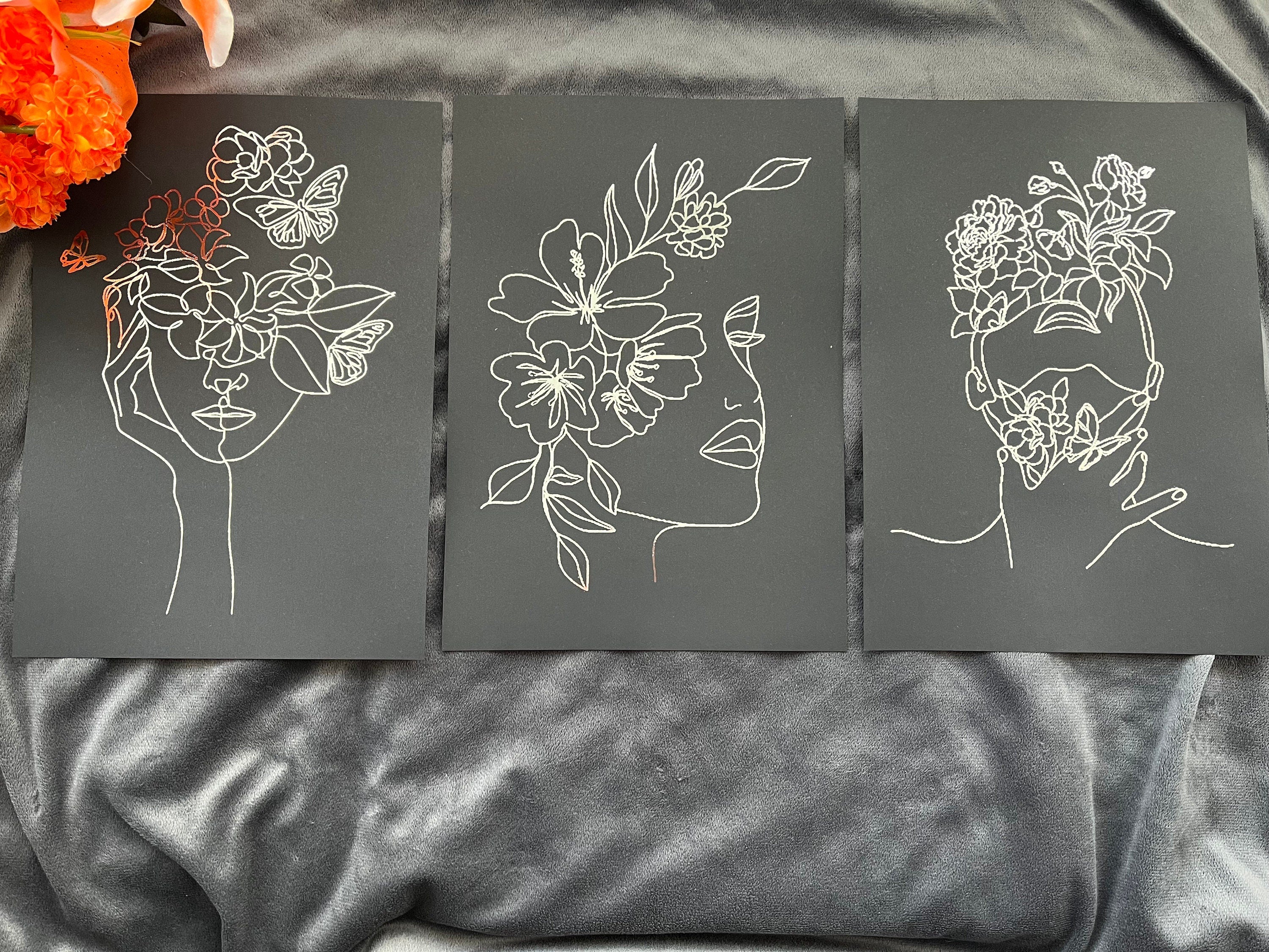 Set of 3 elegant foil prints featuring women's faces in one line drawing style, showcasing a chic black and silver design.