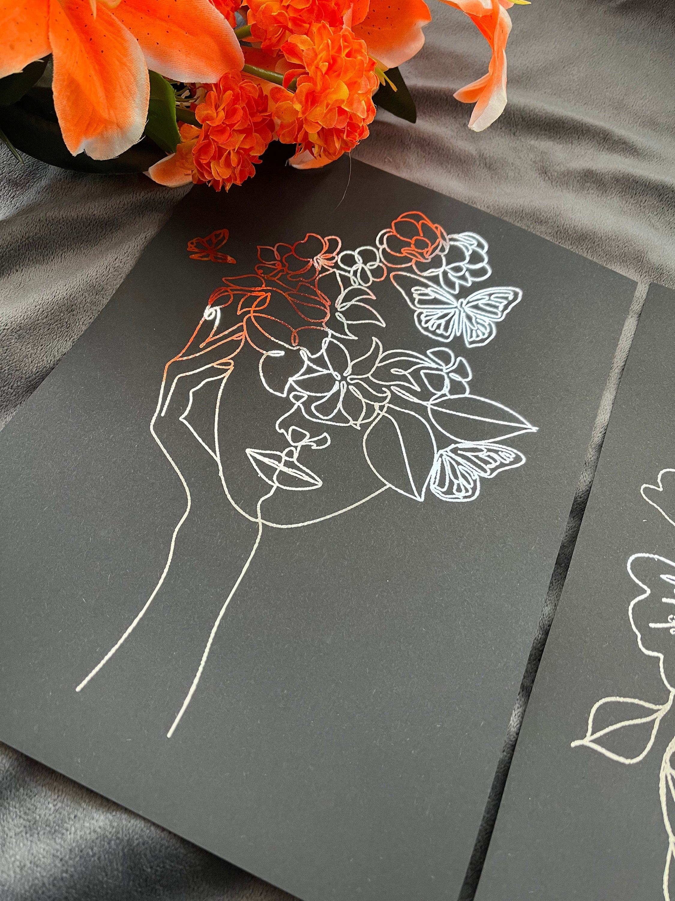 Set of 3 elegant foil prints featuring women's faces in one line drawing style, showcasing a chic black and silver design.