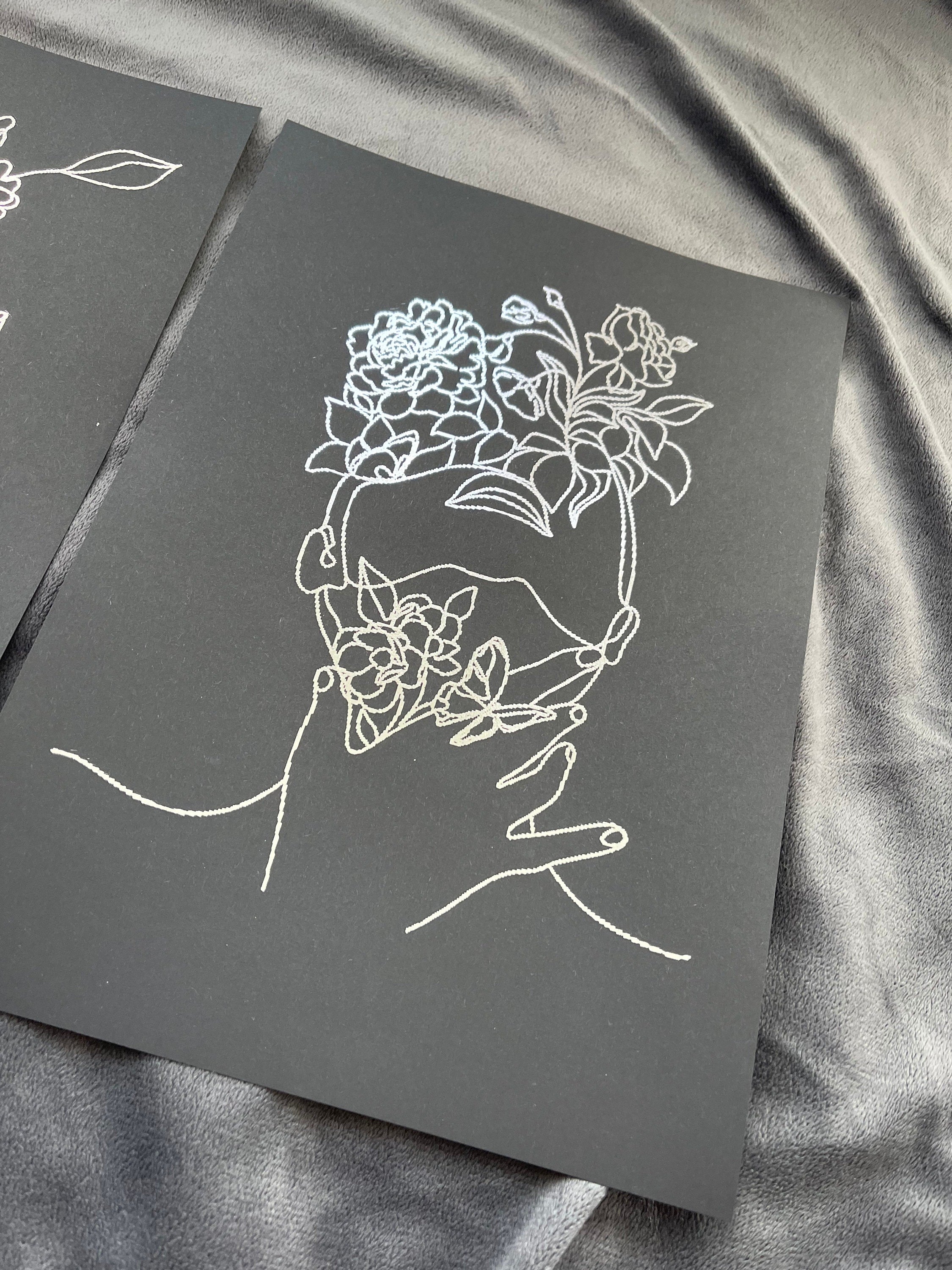 Set of 3 elegant foil prints featuring women's faces in one line drawing style, showcasing a chic black and silver design.