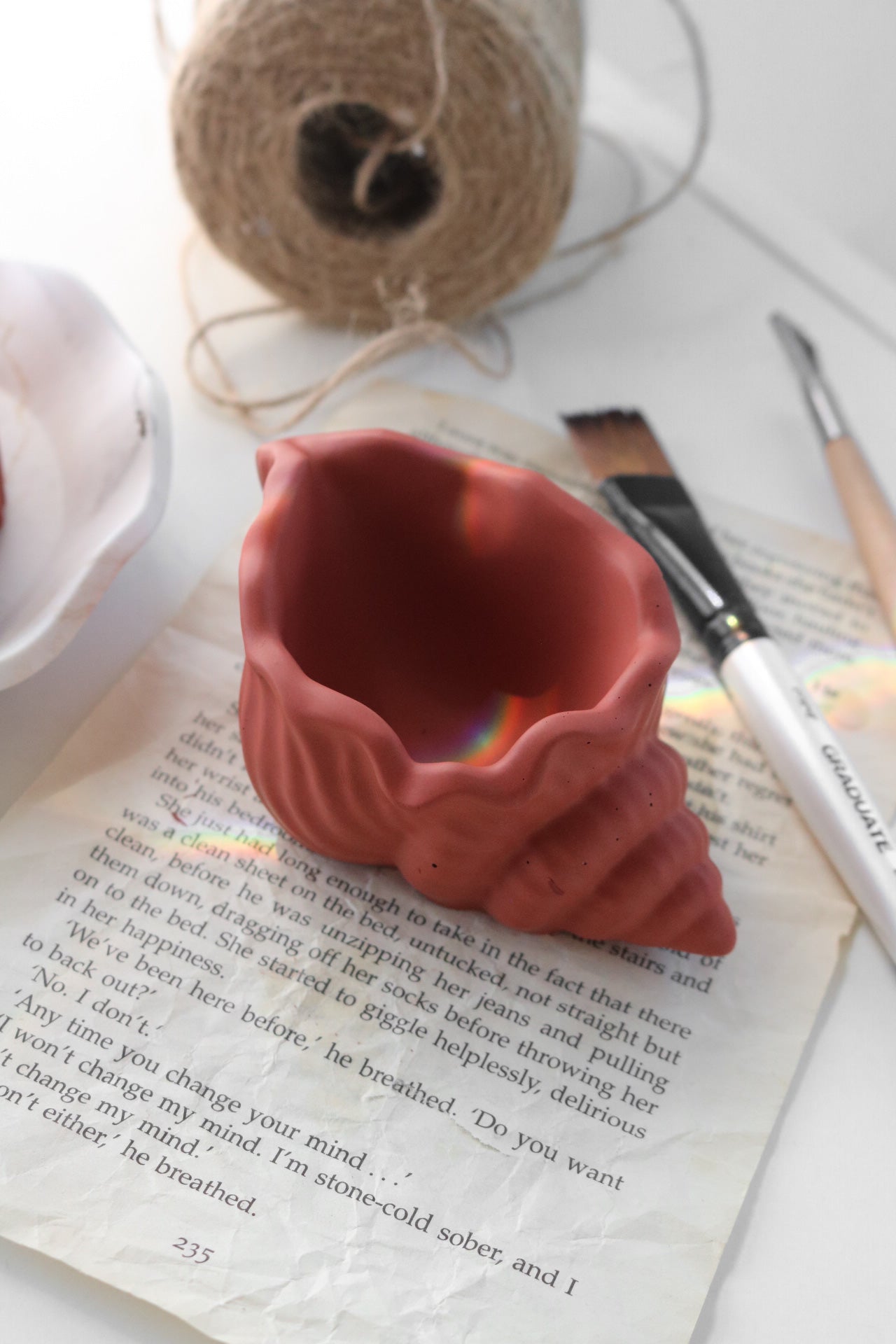 A beautifully crafted shell trinket dish in a soft color, perfect for holding jewelry and accessories, showcasing its unique hand-made finish.