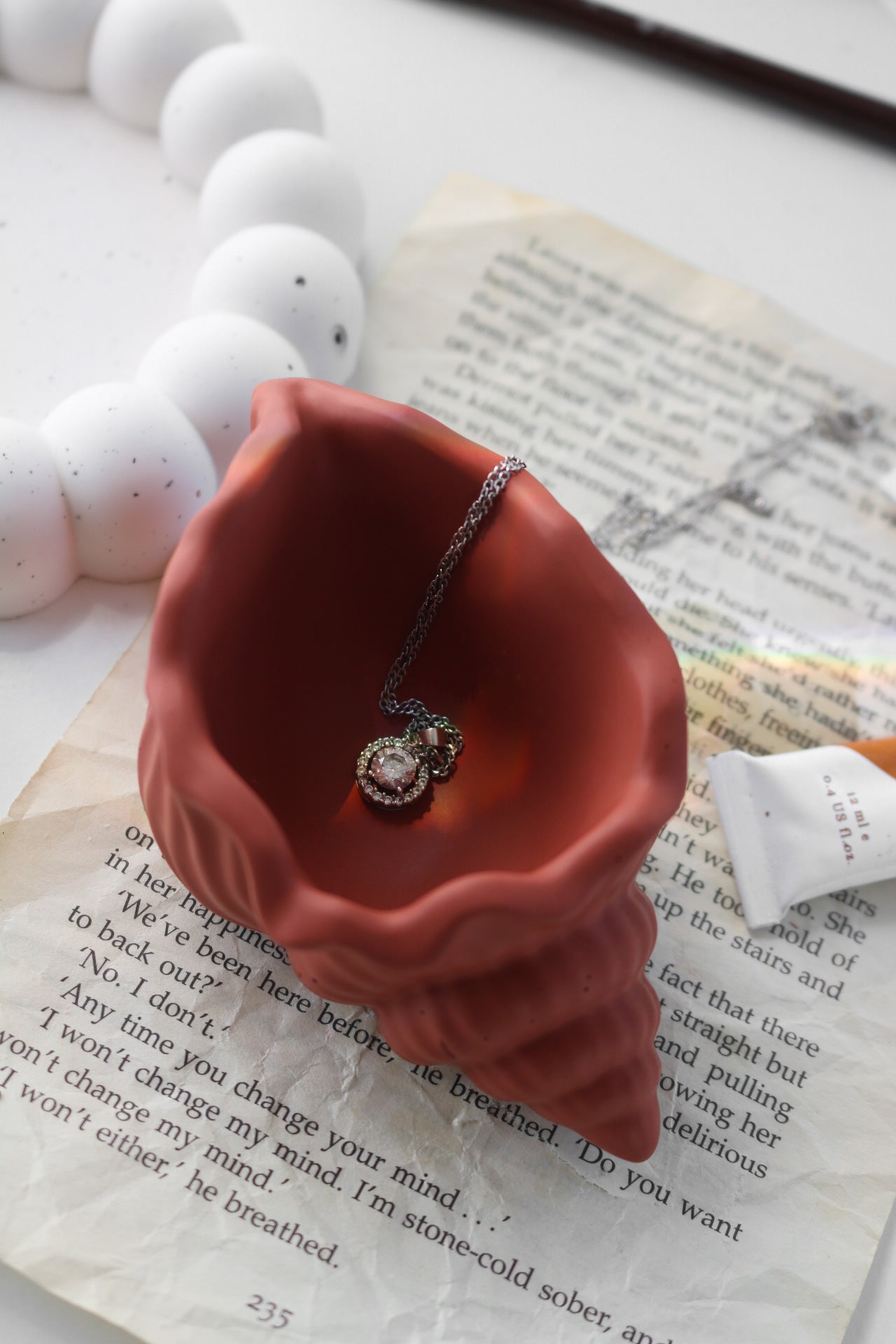 A beautifully crafted shell trinket dish in a soft color, perfect for holding jewelry and accessories, showcasing its unique hand-made finish.