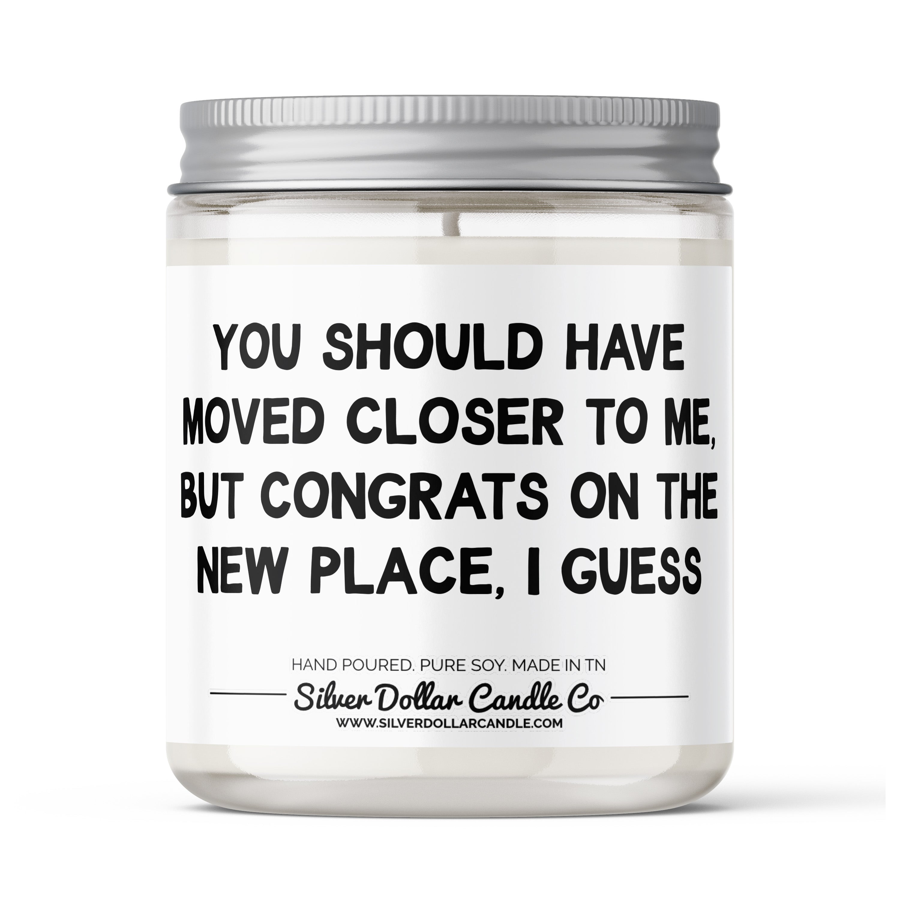 A humorous candle with the phrase 'Should Have Moved Closer To Me' on the label, surrounded by decorative elements.
