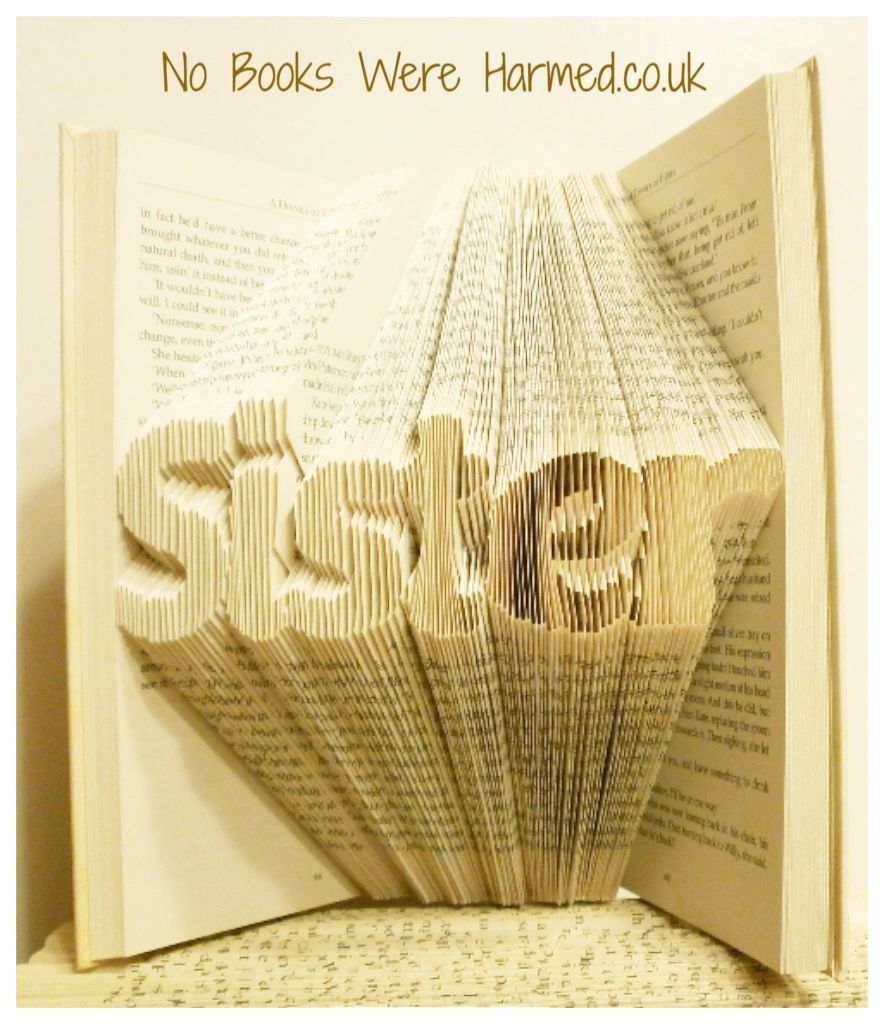 Hand-folded book art titled 'Sister', showcasing intricate designs made from reclaimed vintage books.