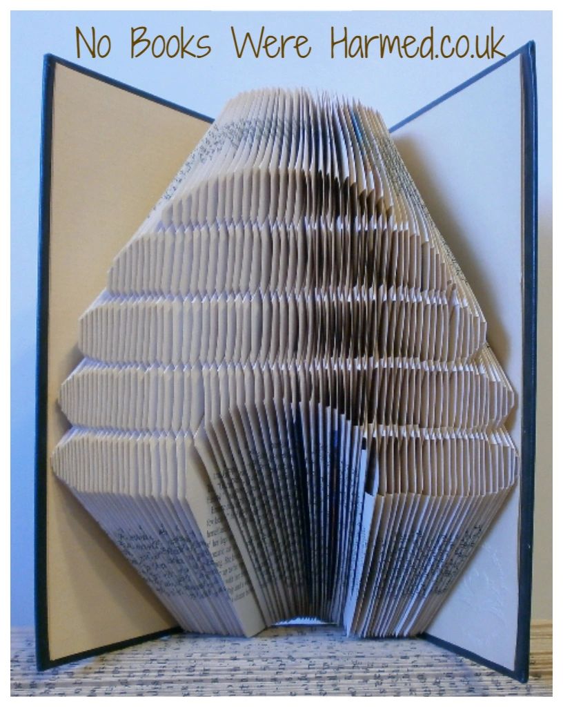 Handcrafted Skep Beehive made from vintage book pages, showcasing intricate folds and unique design.