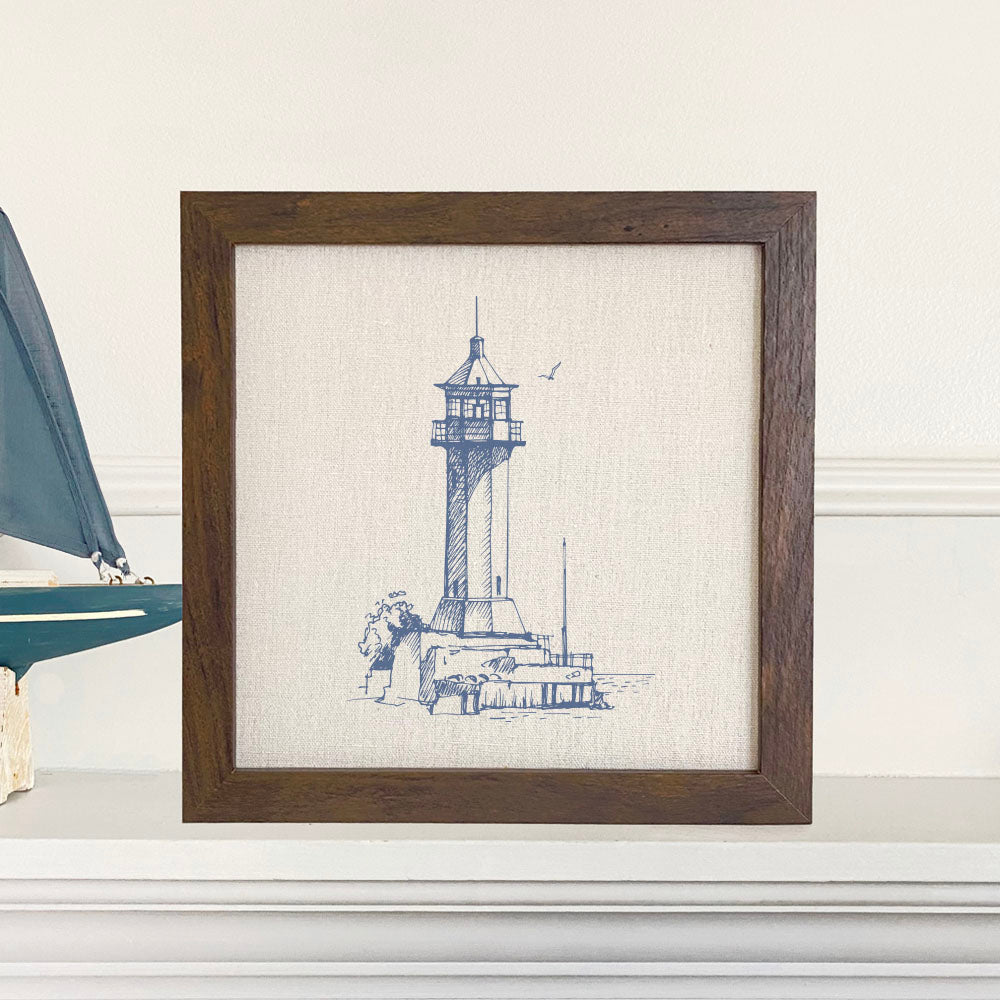Sketched Lighthouse Framed Sign with a wood frame, featuring eco-friendly printing on a linen-look background.