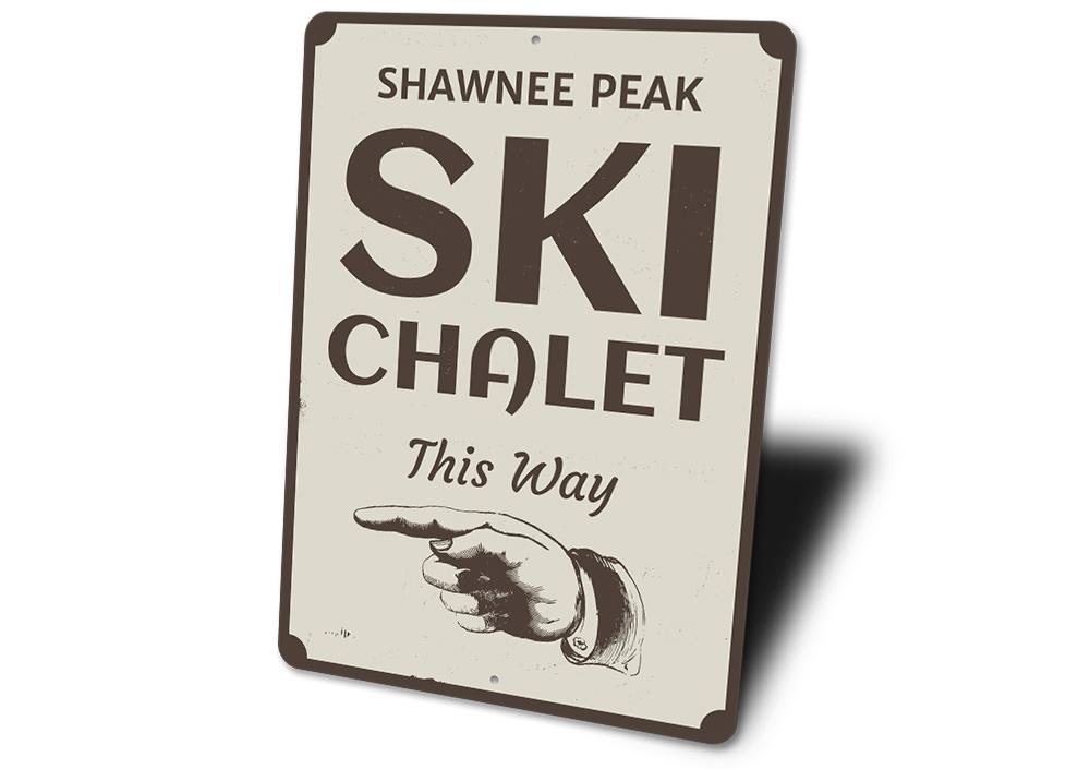 A decorative Ski Chalet This Way Sign made of high-quality aluminum, featuring customizable text options, ideal for ski lovers and lodge decor.