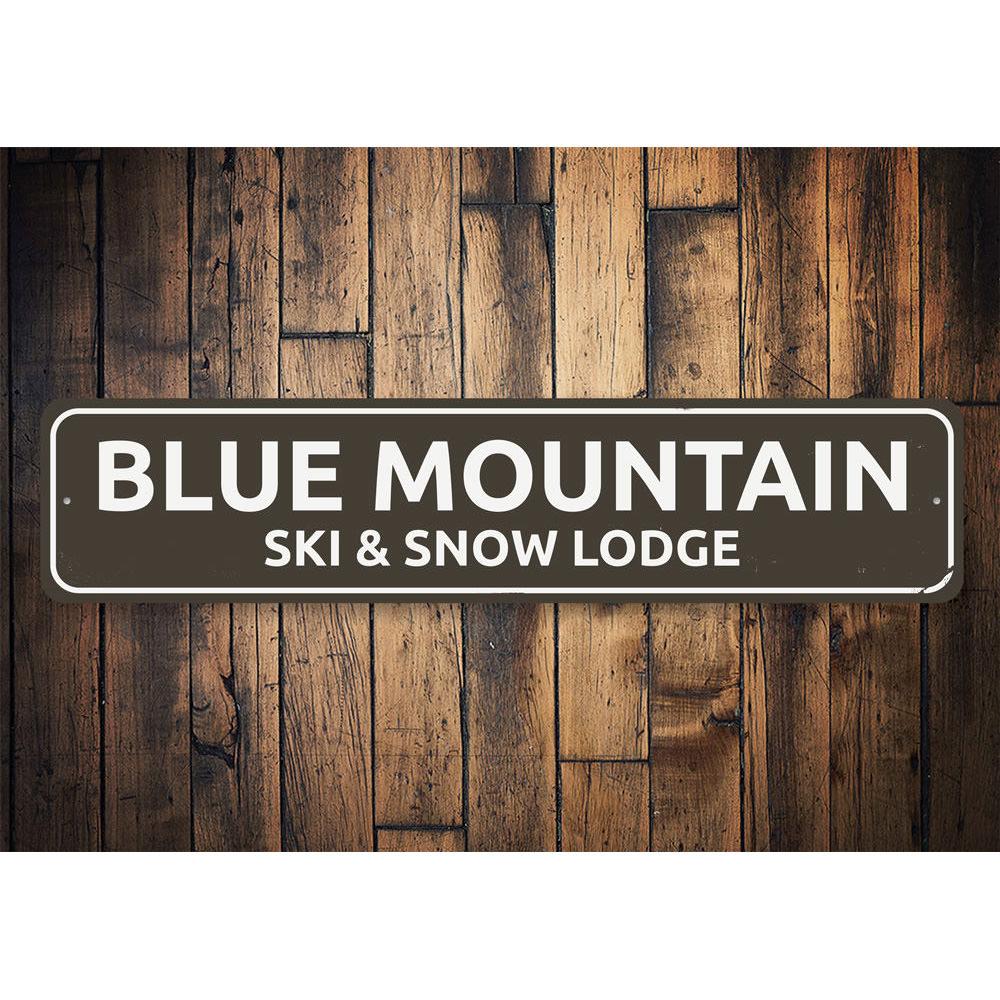 A decorative Ski & Snow Lodge Sign made of high-quality aluminum, featuring customizable text and pre-drilled holes for easy mounting.
