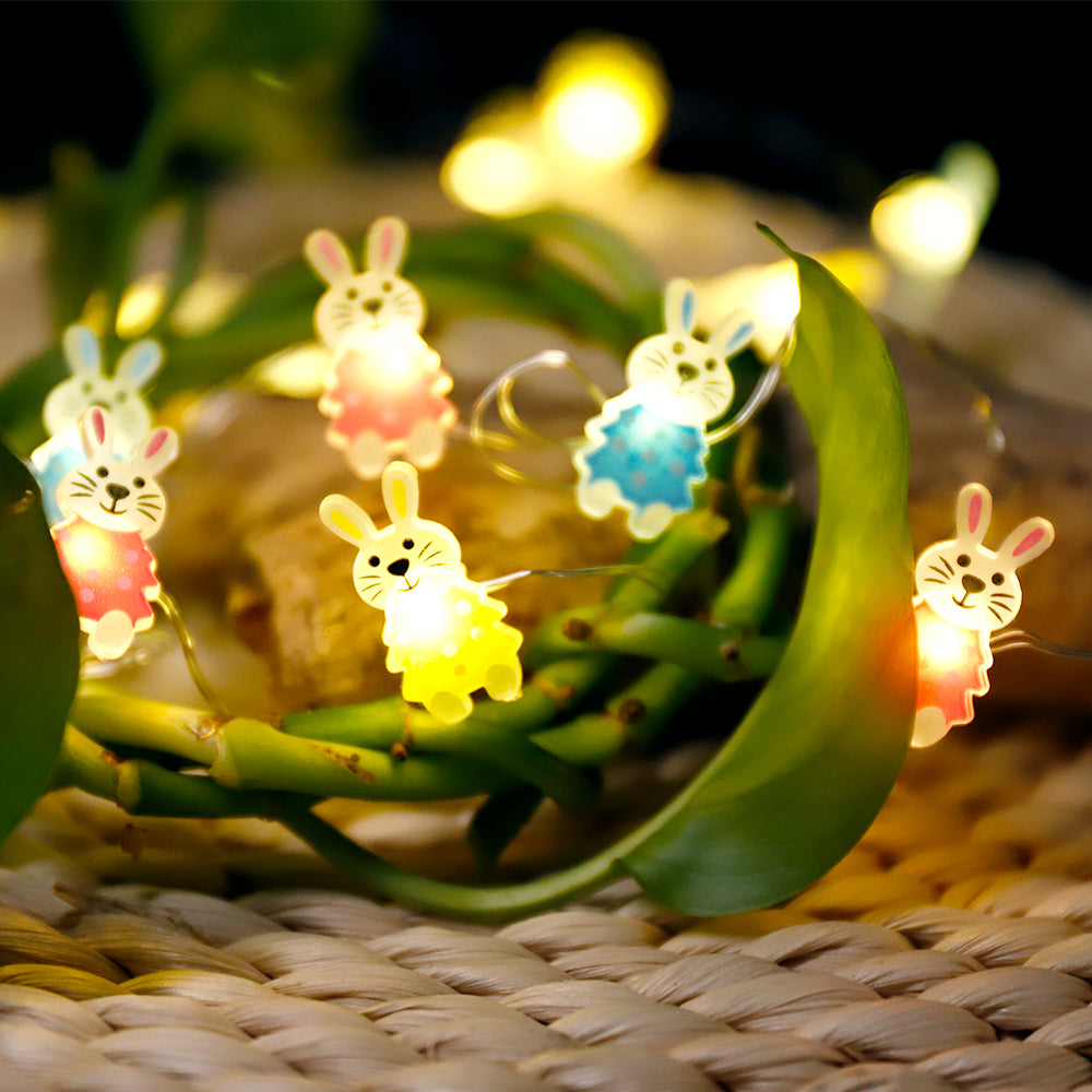 A string of 30 LED bunny-shaped lights, perfect for Easter decorations, showcasing warm white illumination on a copper wire.