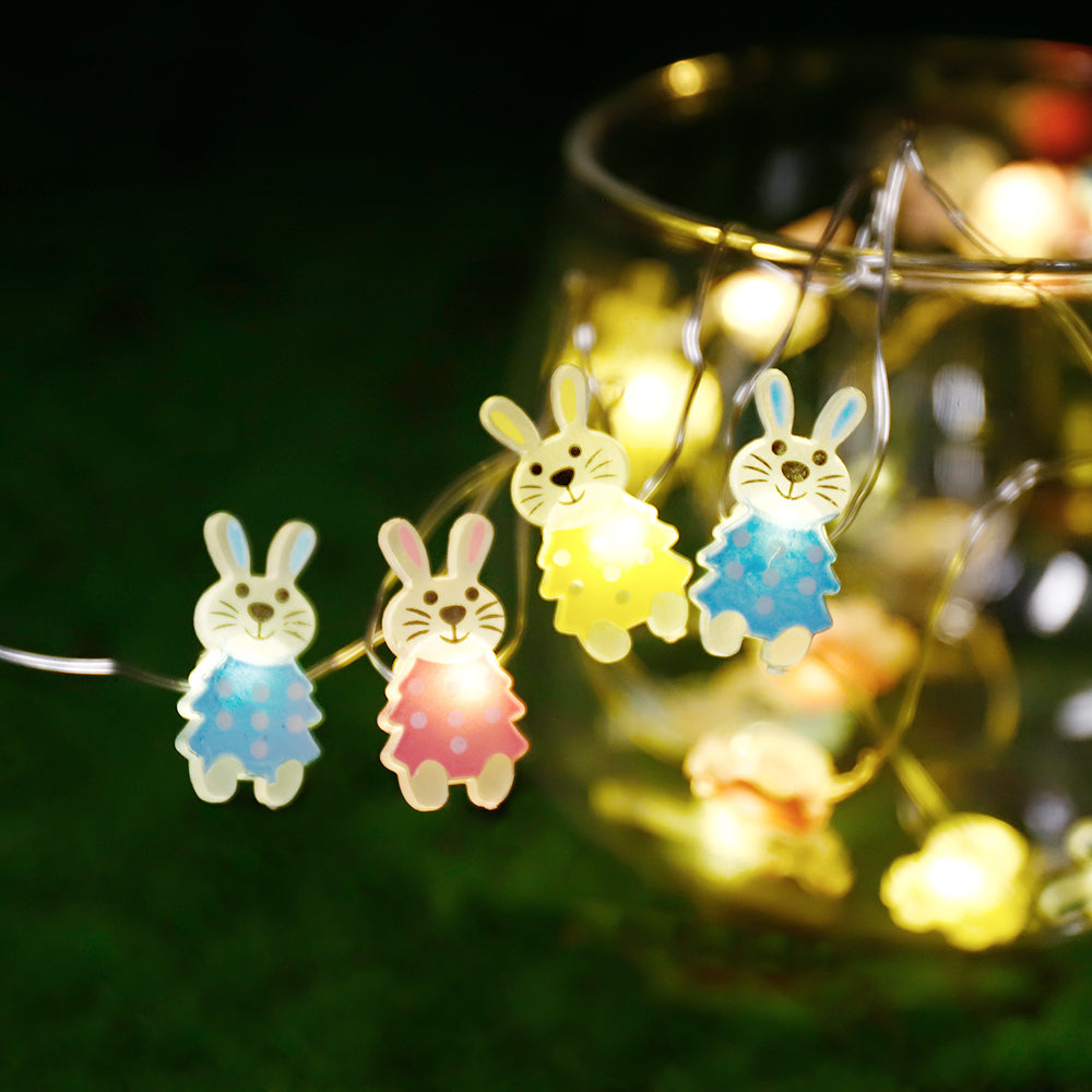 A string of 30 LED bunny-shaped lights, perfect for Easter decorations, showcasing warm white illumination on a copper wire.