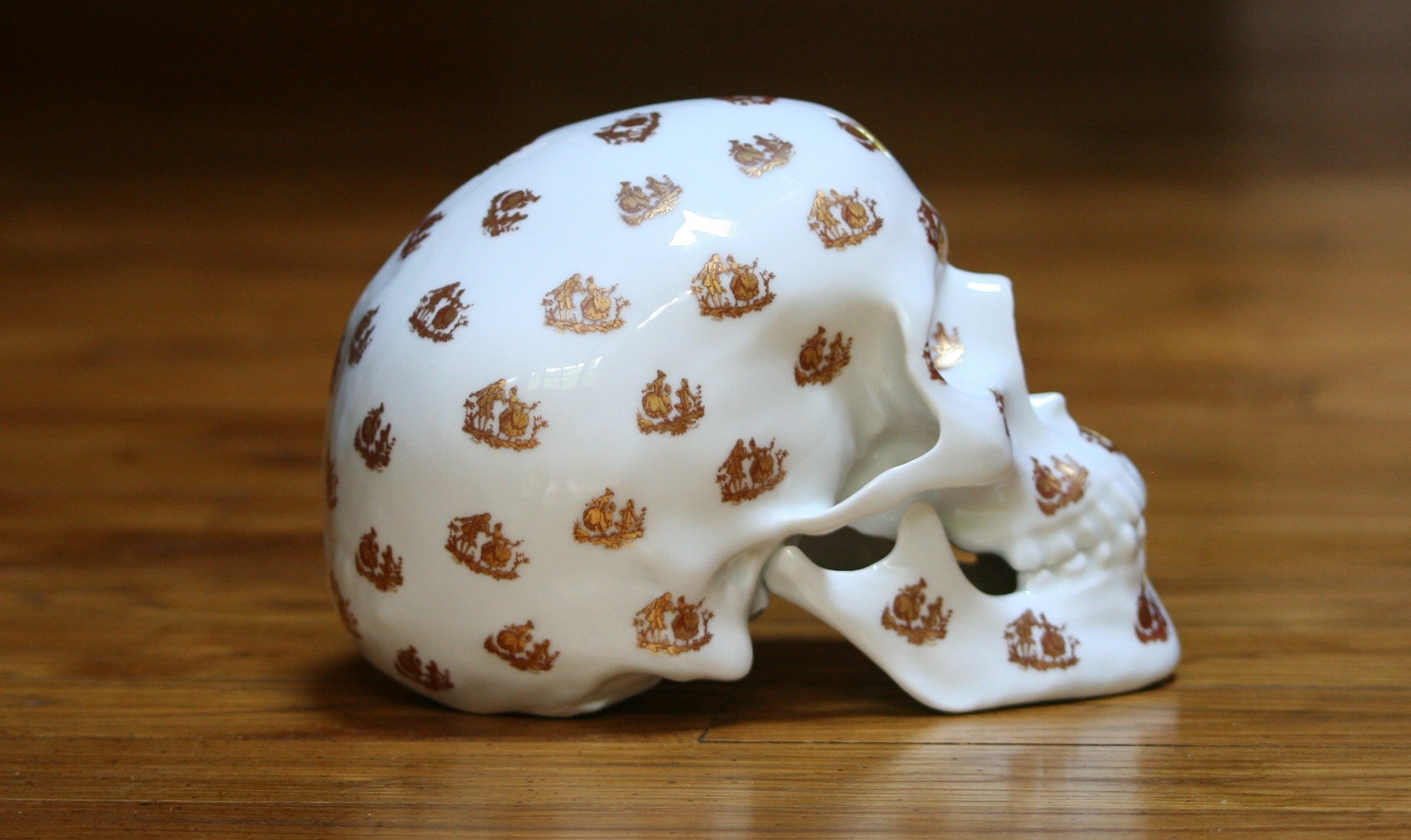 A unique Skull Salutation sculpture by NooN, crafted from extra white porcelain, showcasing intricate artist decor on a skull design.
