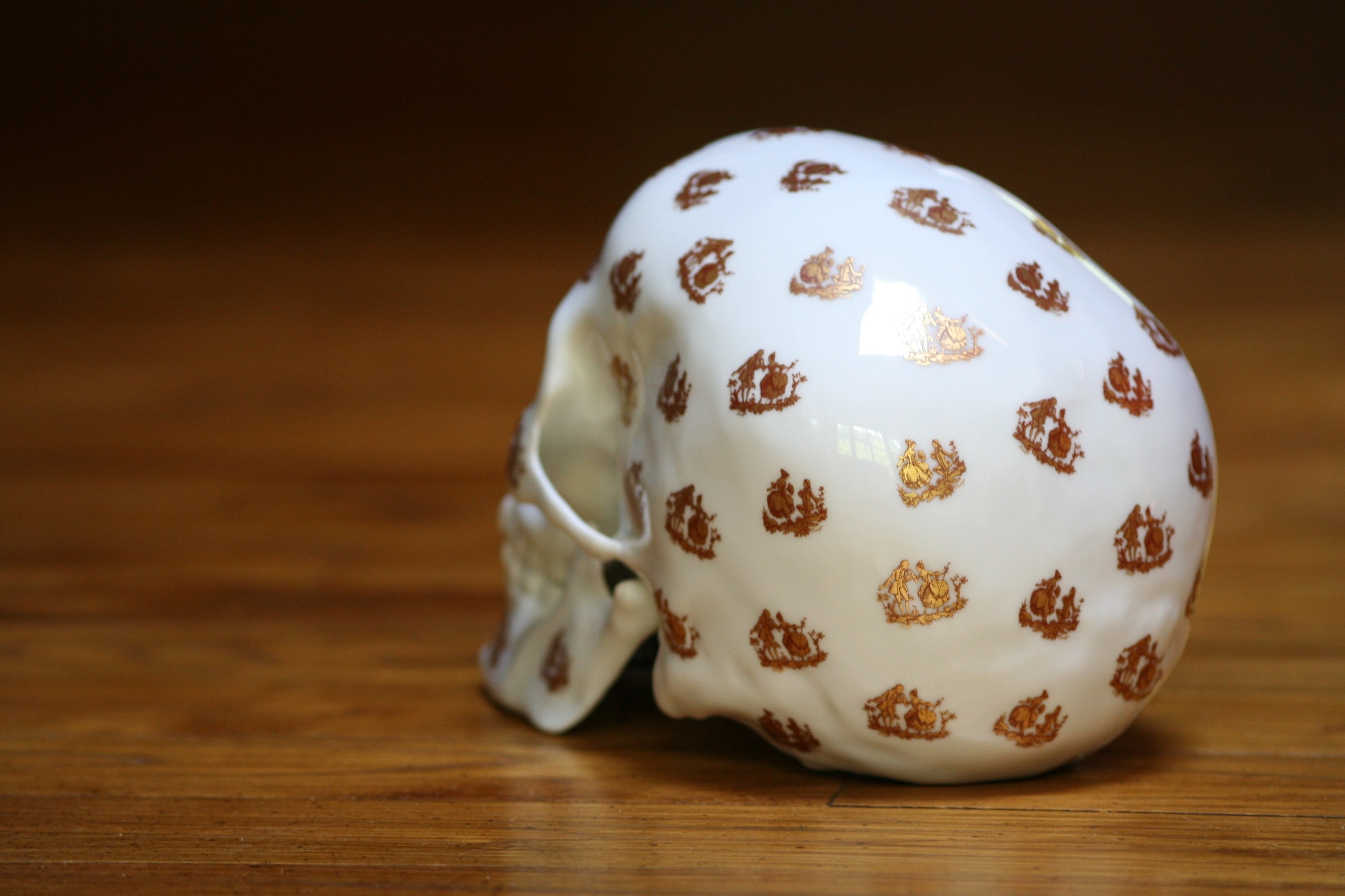 A unique Skull Salutation sculpture by NooN, crafted from extra white porcelain, showcasing intricate artist decor on a skull design.