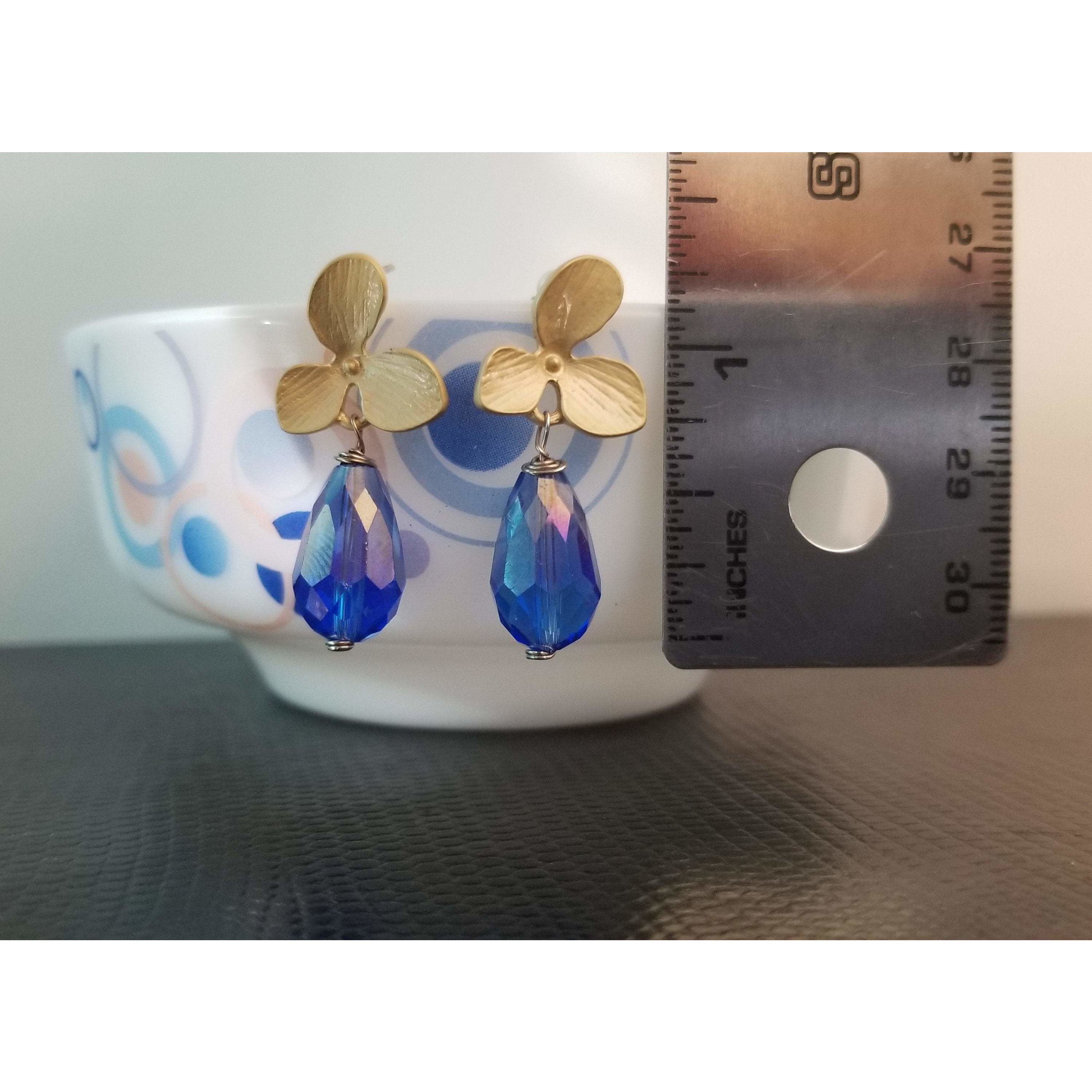 A pair of elegant sky blue crystal teardrop earrings, showcasing their beautiful color and teardrop shape.