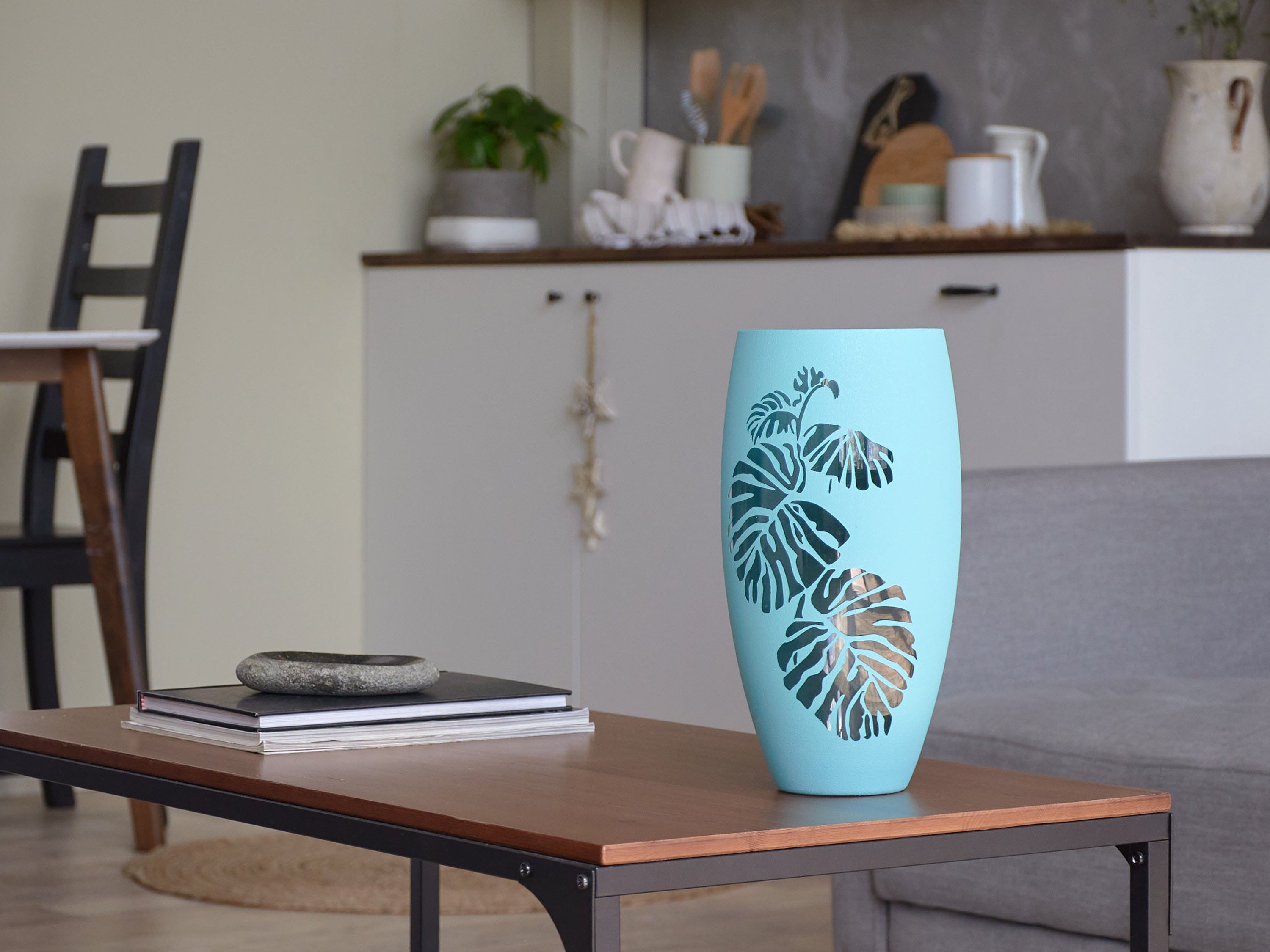 Handmade sky blue glass oval vase with unique hand-painted designs, showcasing artistic flair and elegance.