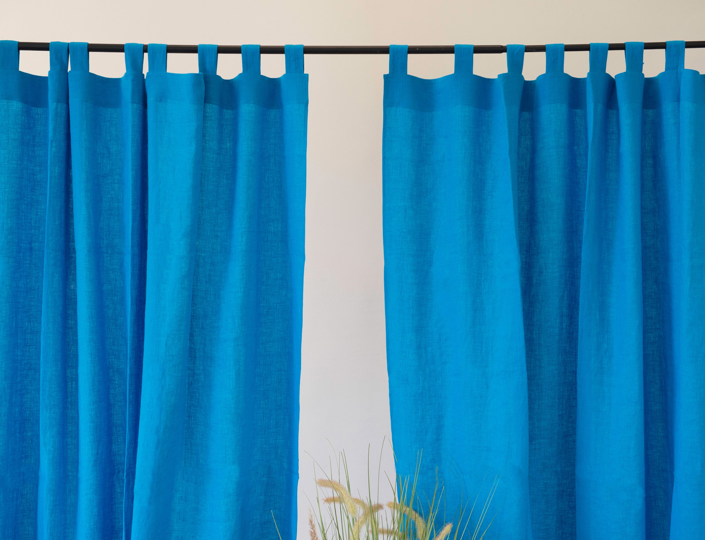 Sky Blue linen curtain with tab tops, showcasing a modern design and semi-sheer fabric.