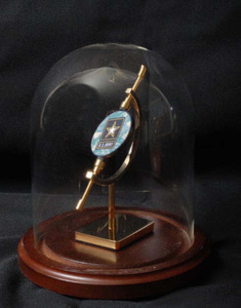 Small challenge coin display holder featuring a glass dome and oak base, designed to hold coins under 1.75 inches.