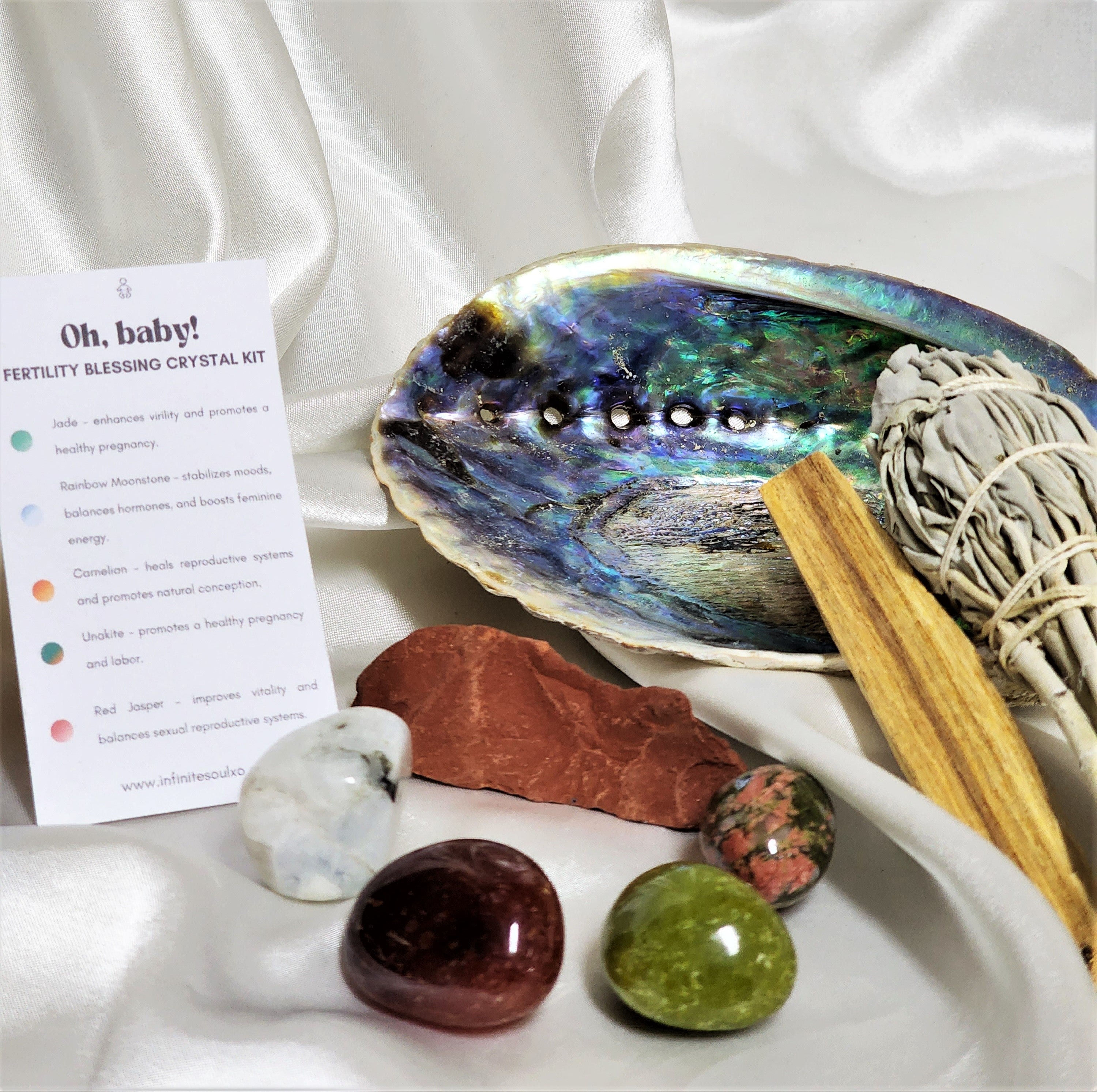 Fertility Blessing Smudge Kit featuring sage smudge stick, Palo Santo wood, abalone shell, and various healing crystals for fertility.