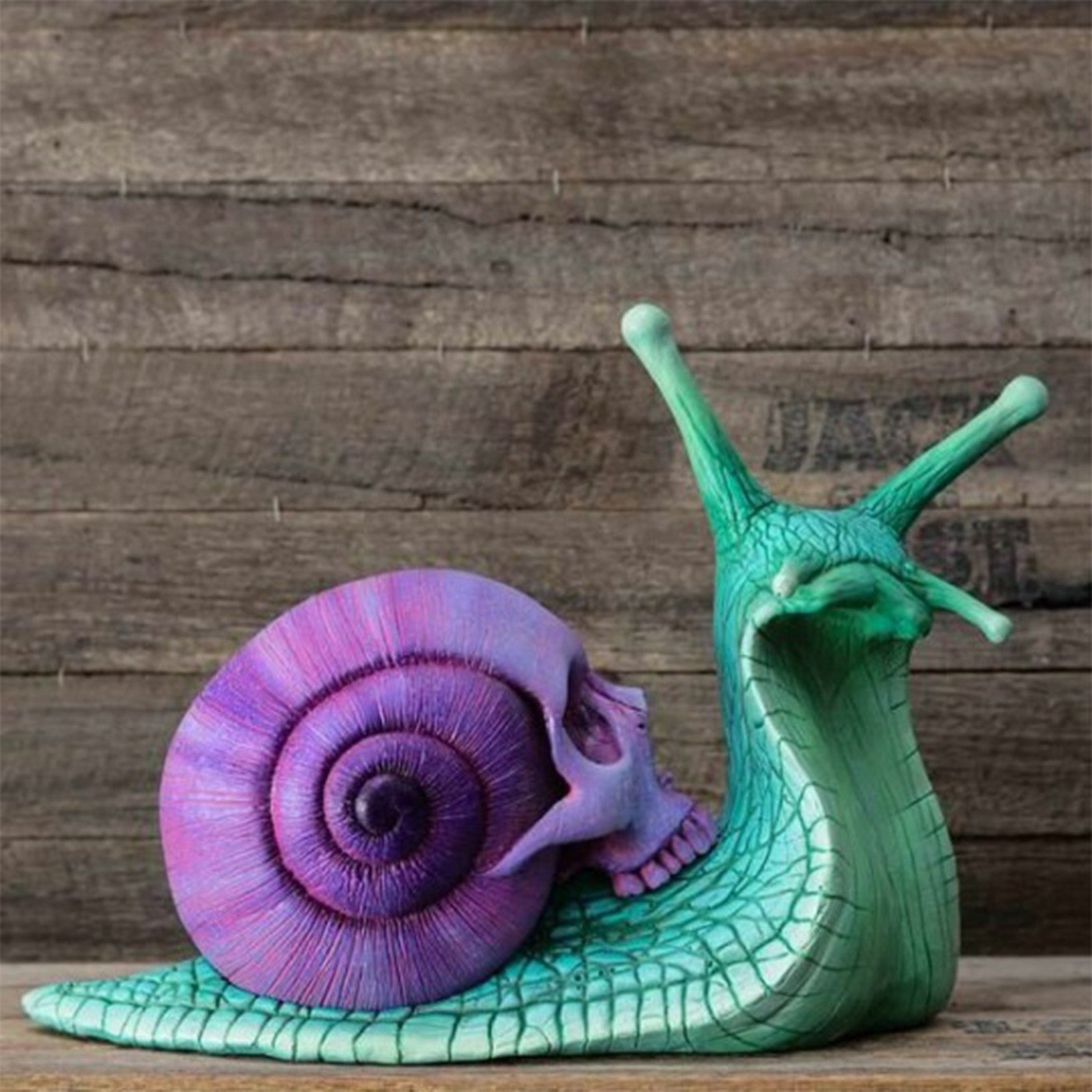 Intricately designed Snail Skull Sculpture in gothic style, showcasing a snail with a skull-shaped shell, perfect for garden or home decor.
