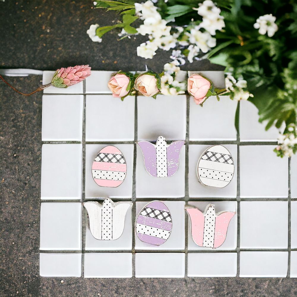 A set of handmade wooden spring accents including tulips and Easter eggs in purple, white, and pink, perfect for seasonal decor.