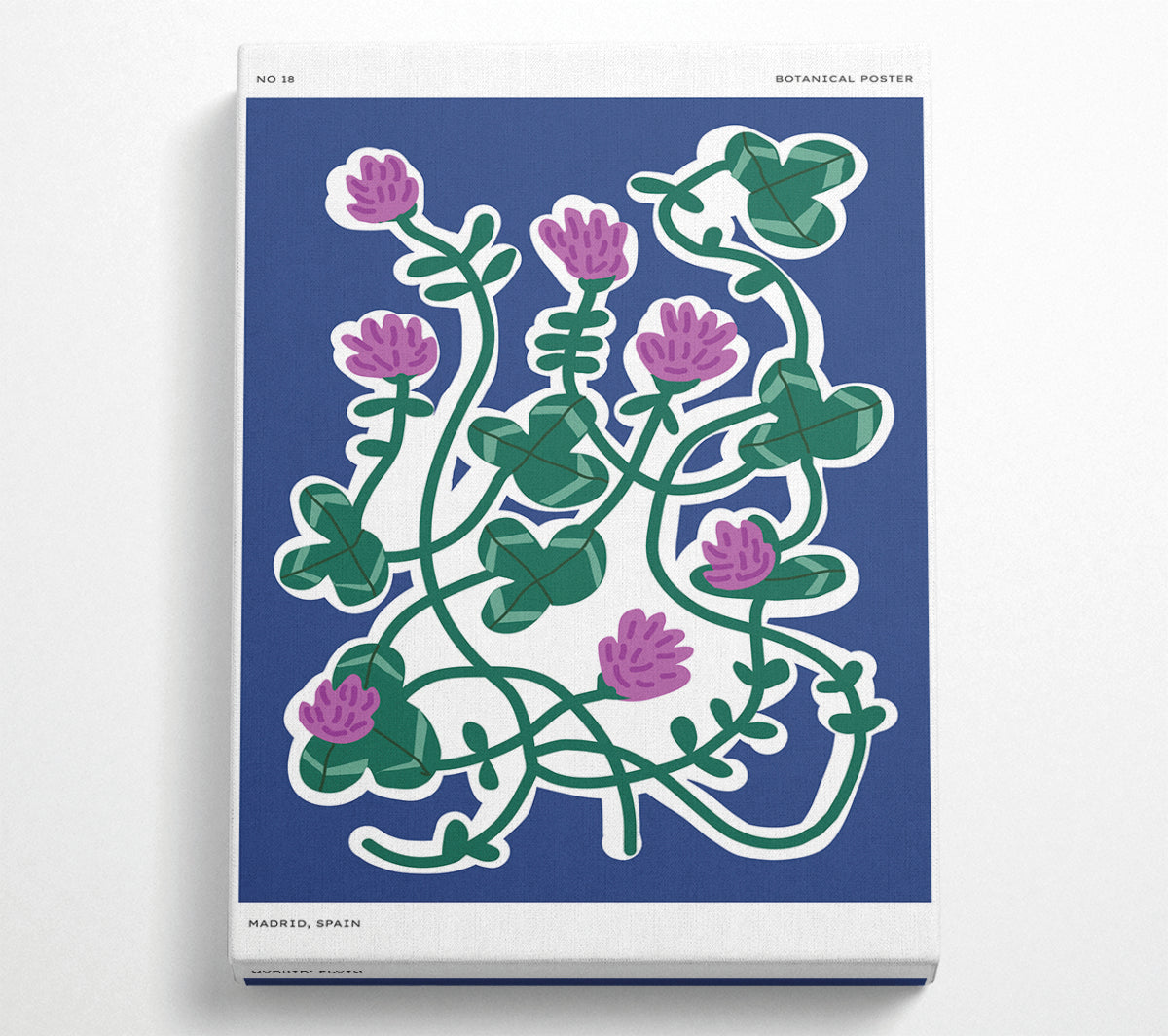 A vibrant canvas print featuring spring flowers on a purple background, mounted on a sturdy box frame, ready to hang.