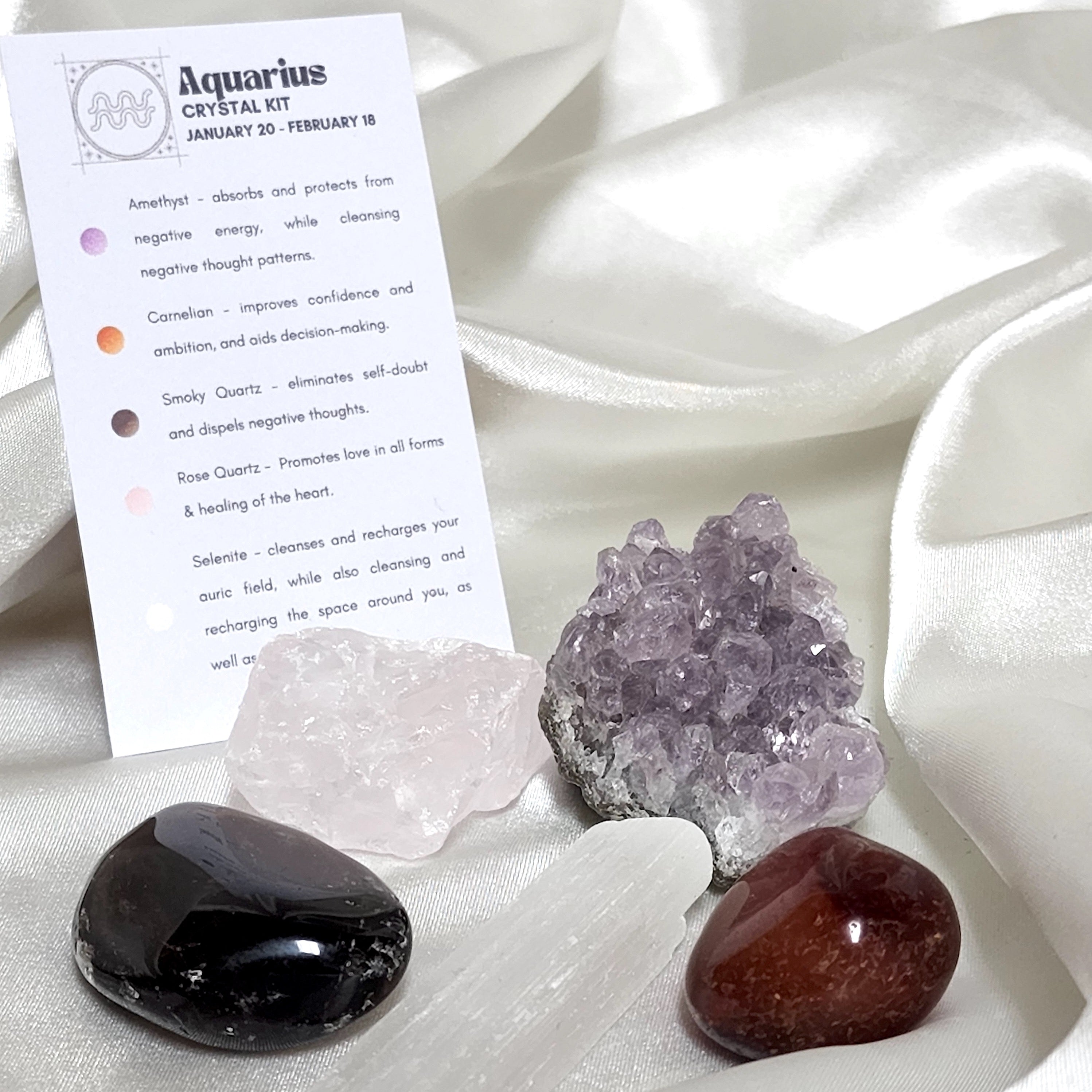 Aquarius Star Sign Crystal Healing Kit featuring Selenite, Rose Quartz, Amethyst, Carnelian, and Smoky Quartz in an elegant display.