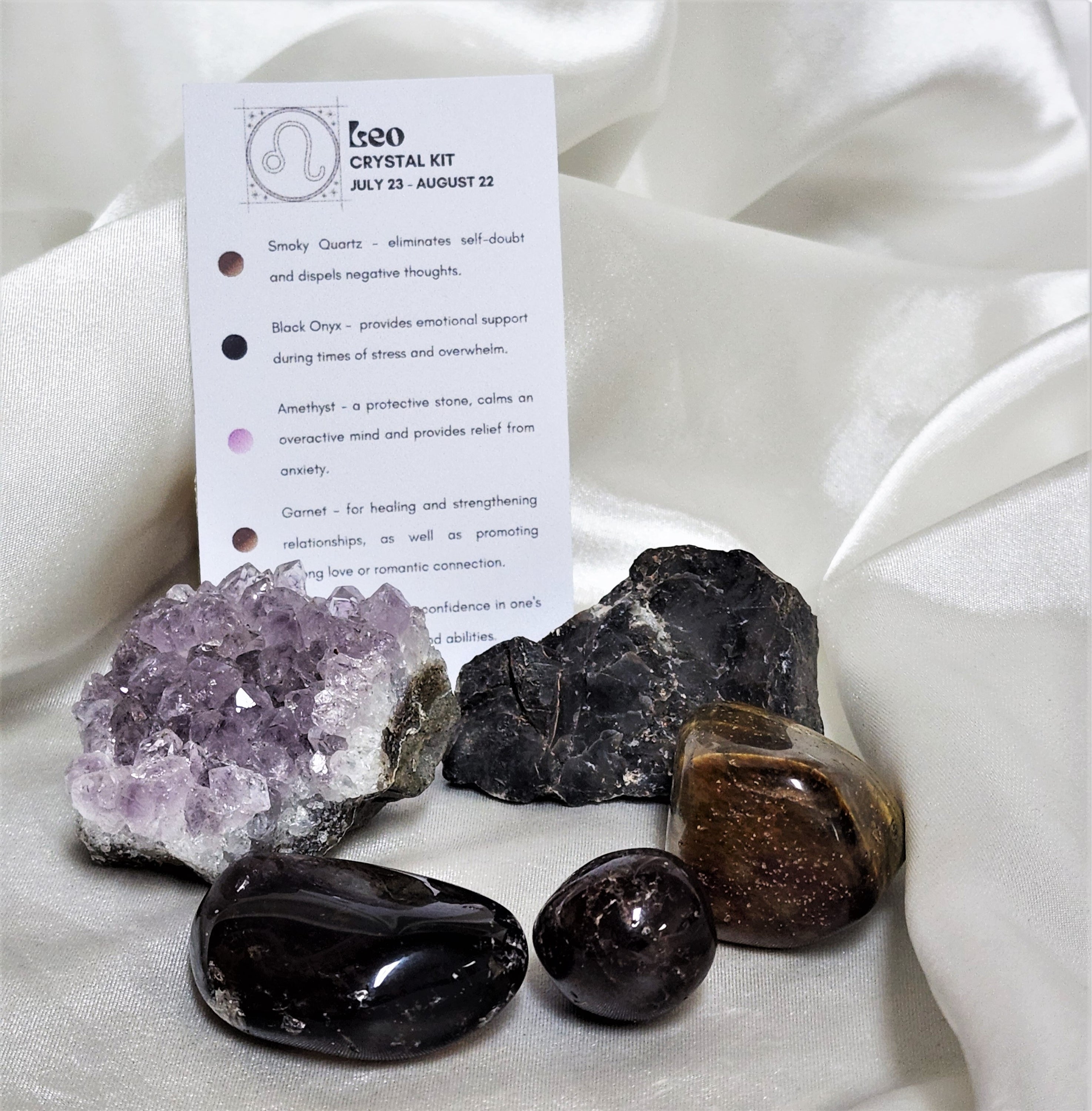 Star Sign Crystal Healing Kit for Leo featuring Amethyst, Tiger's Eye, Garnet, Black Onyx, and Smoky Quartz in a beautifully arranged display.