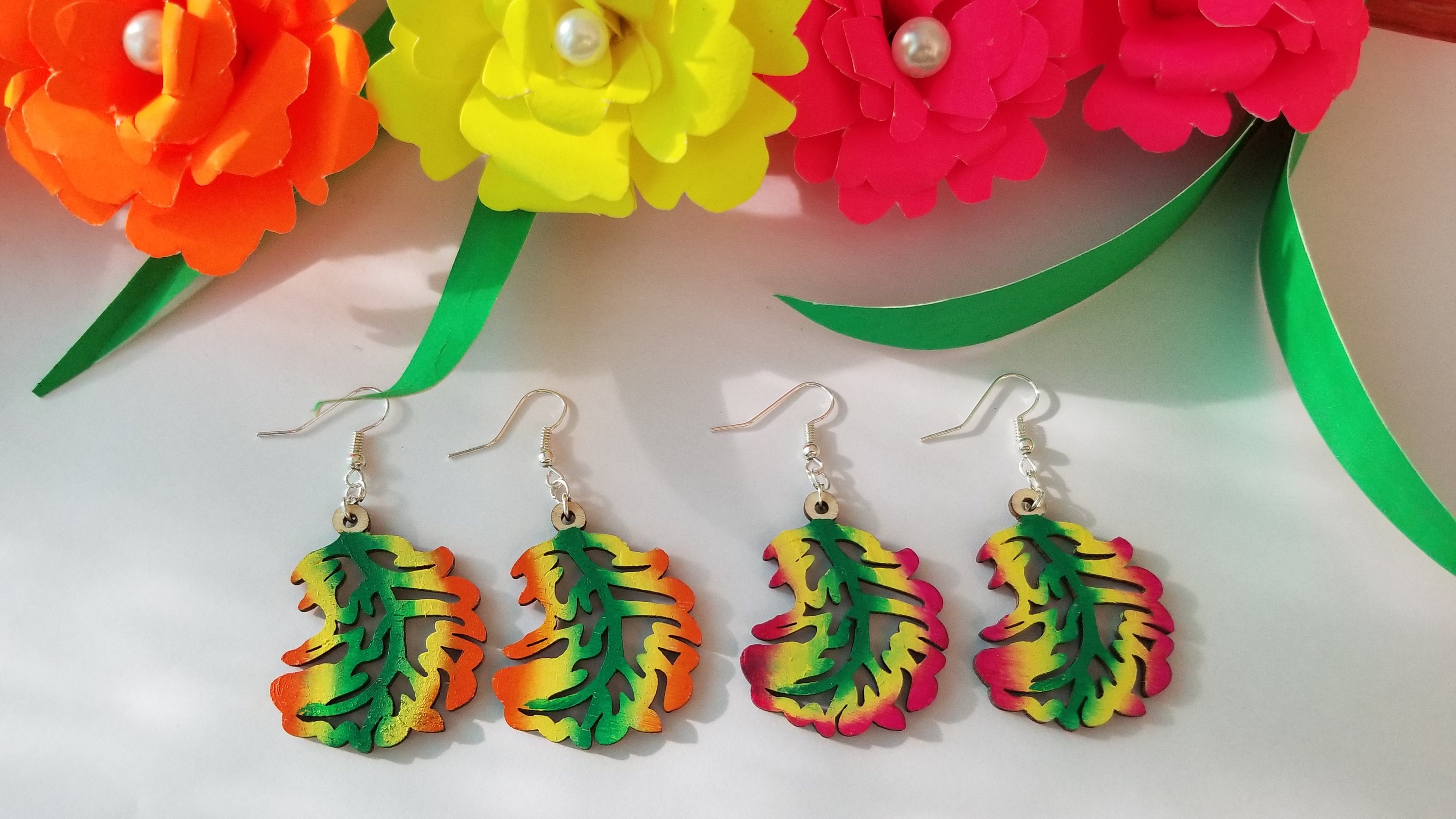 Handmade wooden autumn leaf earrings with stainless steel ear wire, showcasing intricate leaf design and vibrant colors.