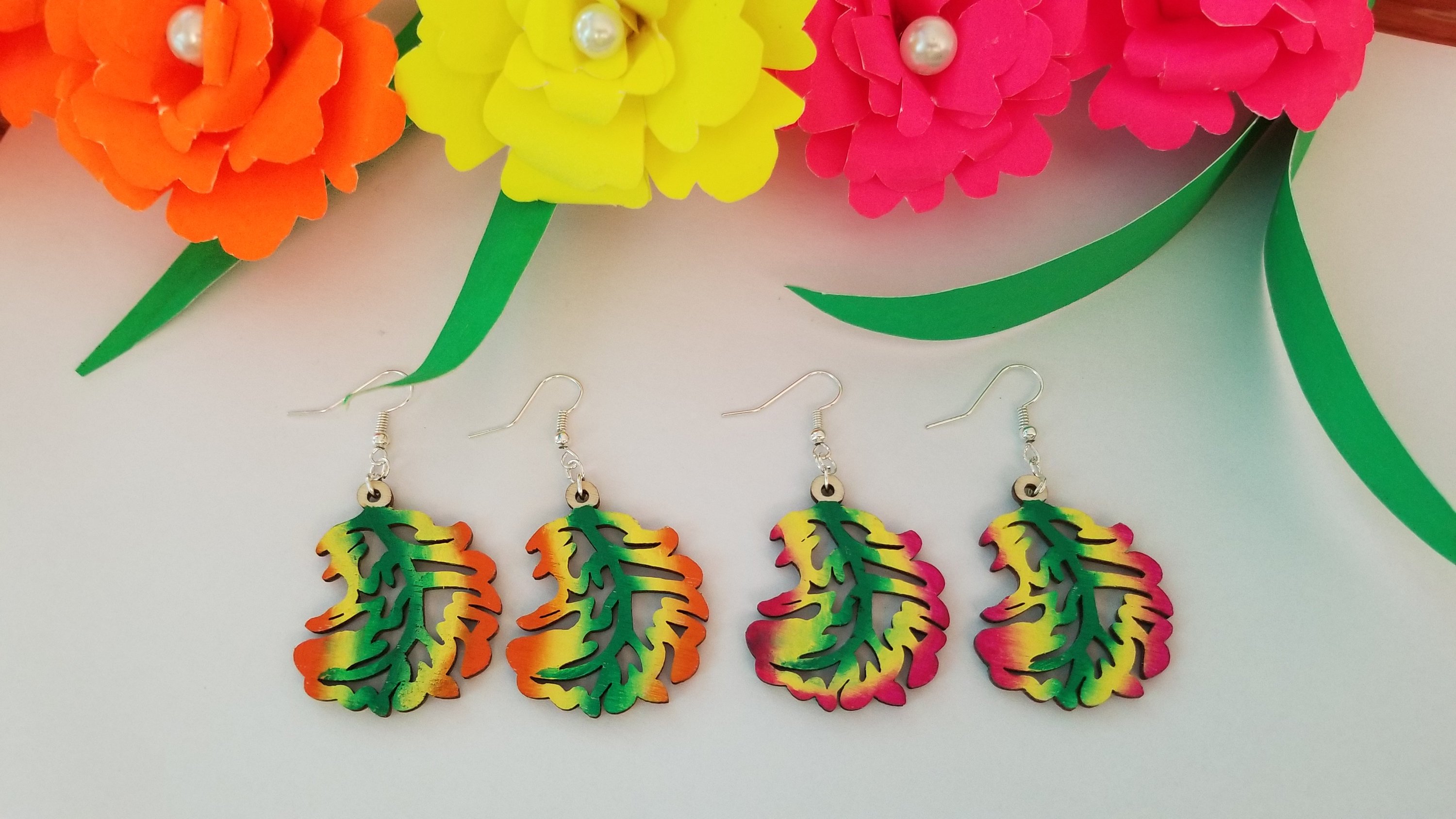 Handmade wooden autumn leaf earrings with stainless steel ear wire, showcasing intricate leaf design and vibrant colors.