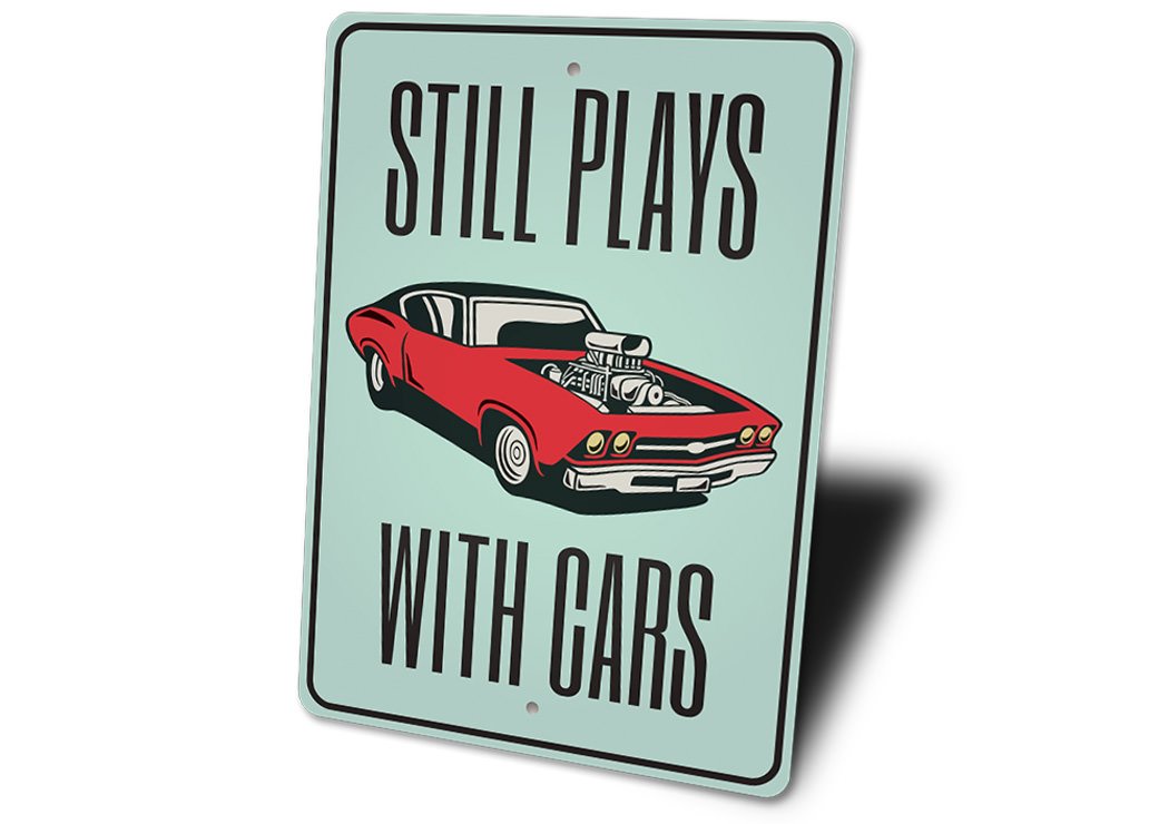 Still Plays With Cars Garage Sign made from high-quality aluminum, featuring a humorous design perfect for car enthusiasts.