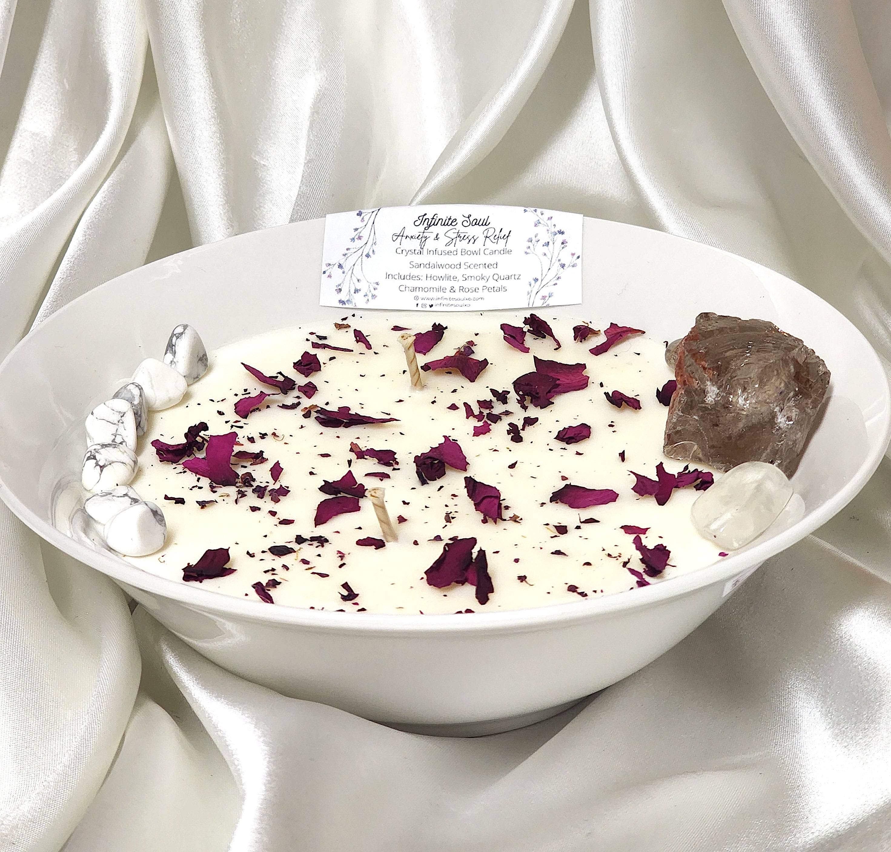 Stress Less Crystal Infused Bowl Candle with sandalwood scent, featuring Howlite and Smoky Quartz crystals, adorned with rose petals and chamomile buds.