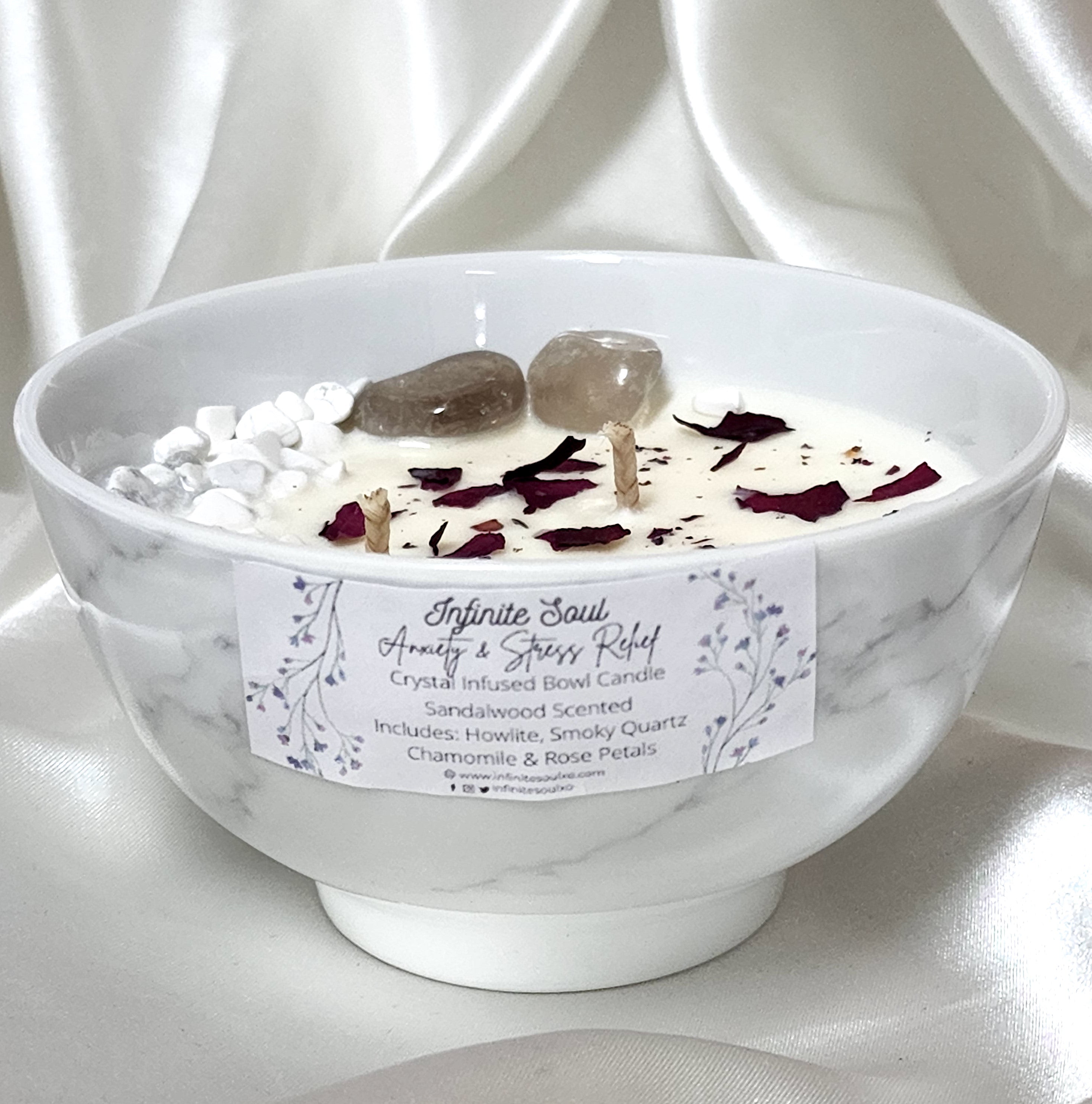 Stress Less Crystal Infused Bowl Candle with sandalwood scent, featuring Howlite and Smoky Quartz crystals, adorned with rose petals and chamomile buds.