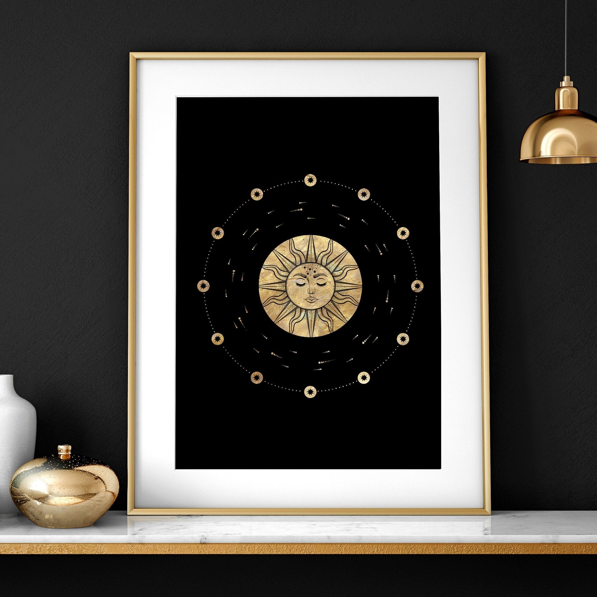 Set of three framed wall art prints featuring intricate sun and moon designs in a radiant gold finish, perfect for bohemian decor.
