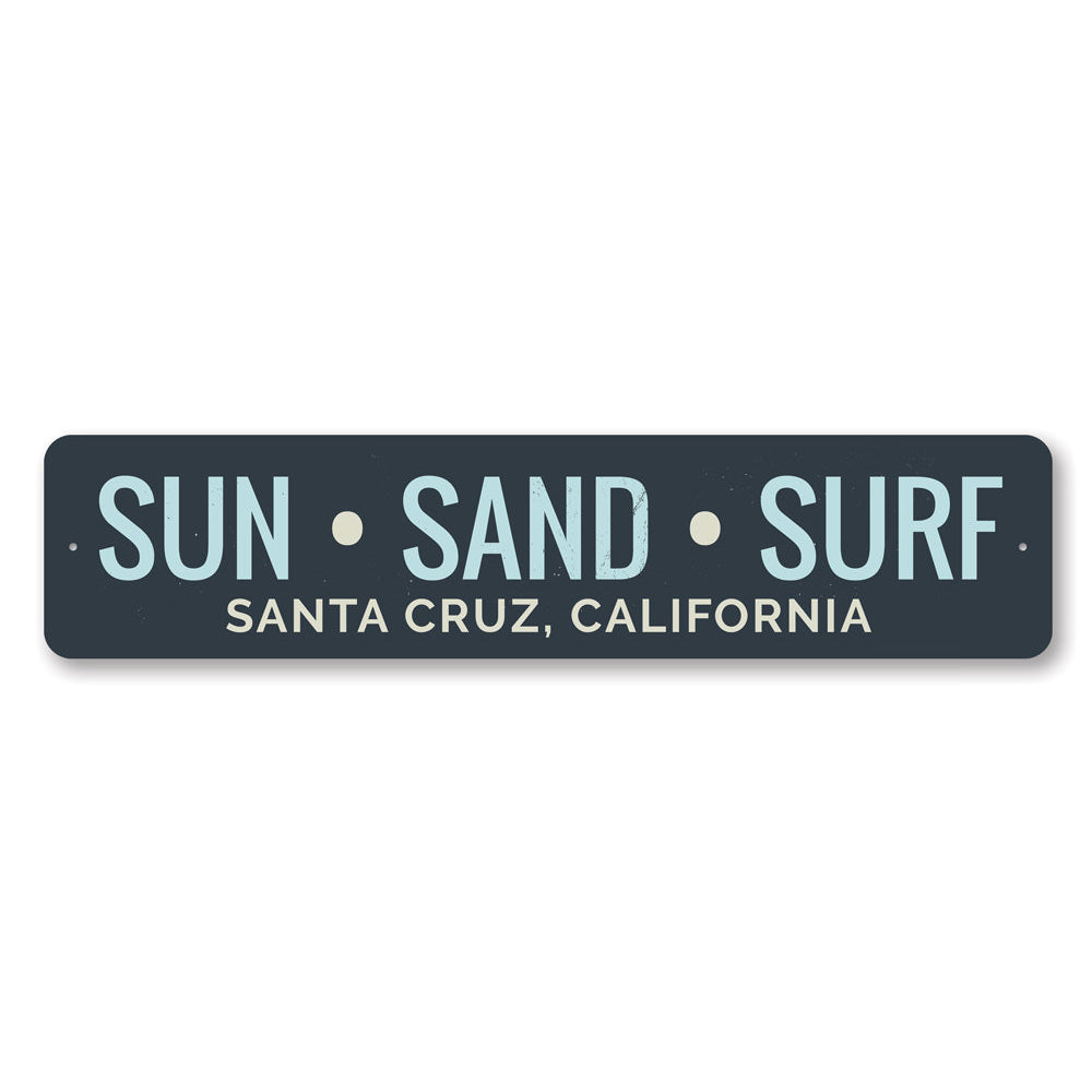 A decorative Sun Sand Surf Sign made of aluminum, featuring beach-themed graphics and customizable text, perfect for coastal decor.
