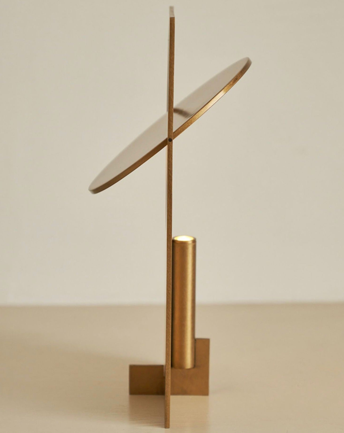 A modern Sunset Table Lamp made of stainless steel, showcasing a unique design that reflects warm light, perfect for living rooms and bedrooms.