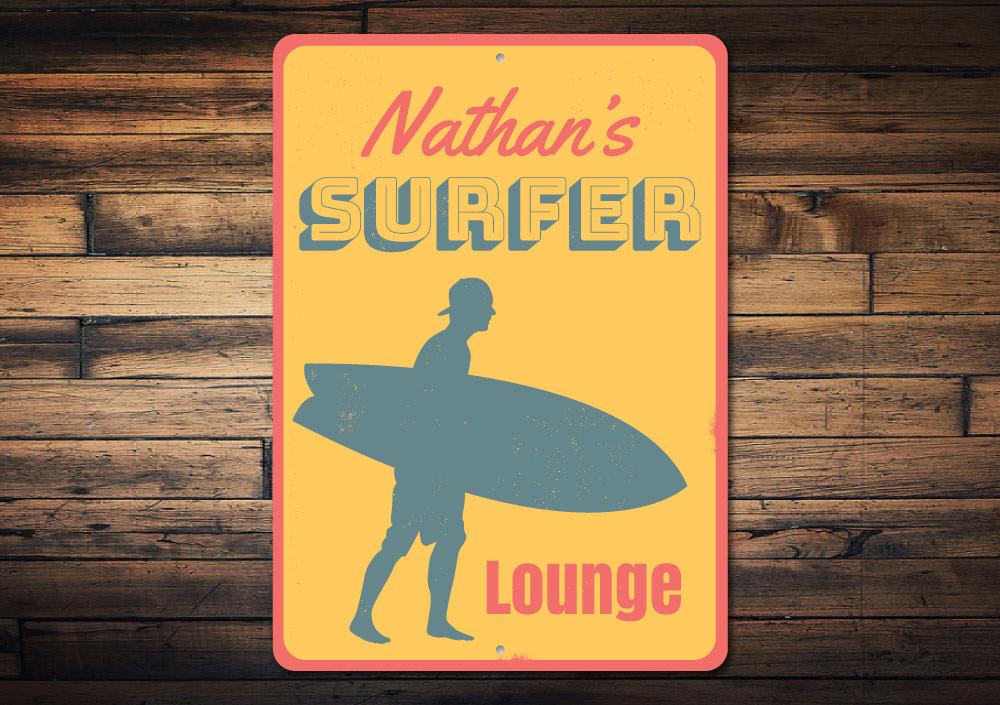 A decorative Surfer Lounge Sign made of high-quality aluminum, featuring a beach-themed design perfect for coastal decor.