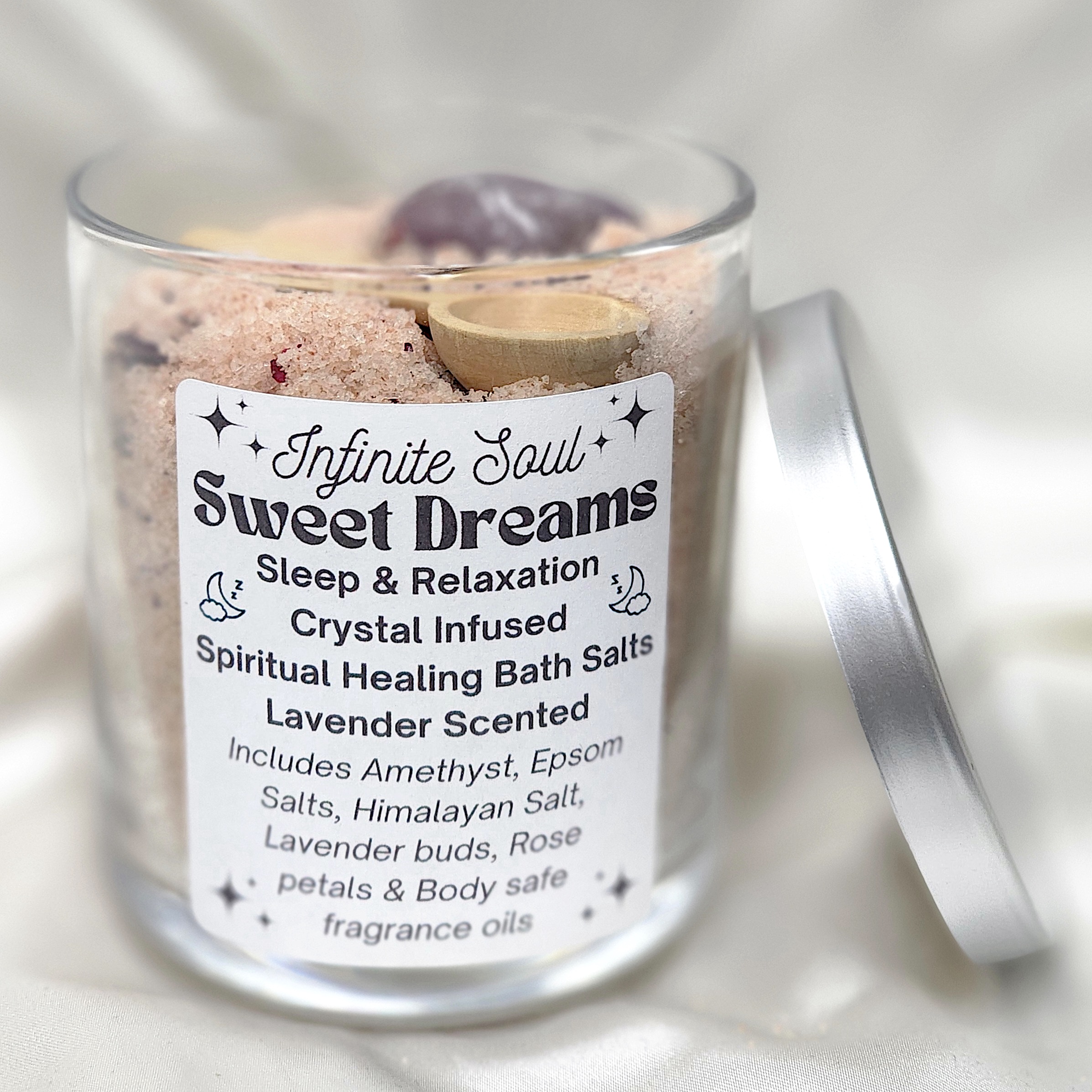 A jar of Sweet Dreams Crystal Infused Bath Salts with lavender buds and an Amethyst crystal, showcasing relaxation and self-care.