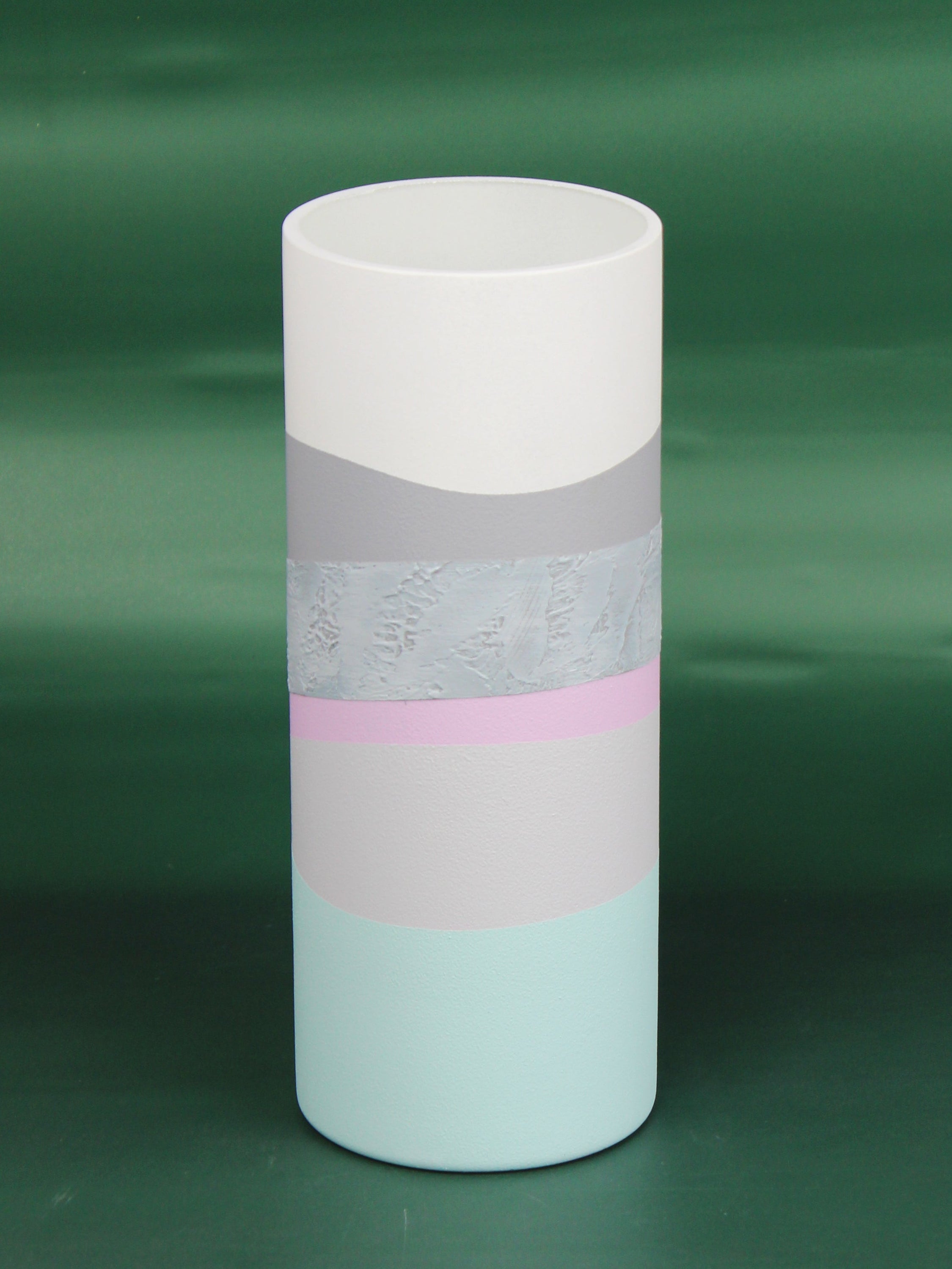 A hand-painted gray decorative glass vase with unique artistic designs, showcasing its elegant shape and intricate patterns.