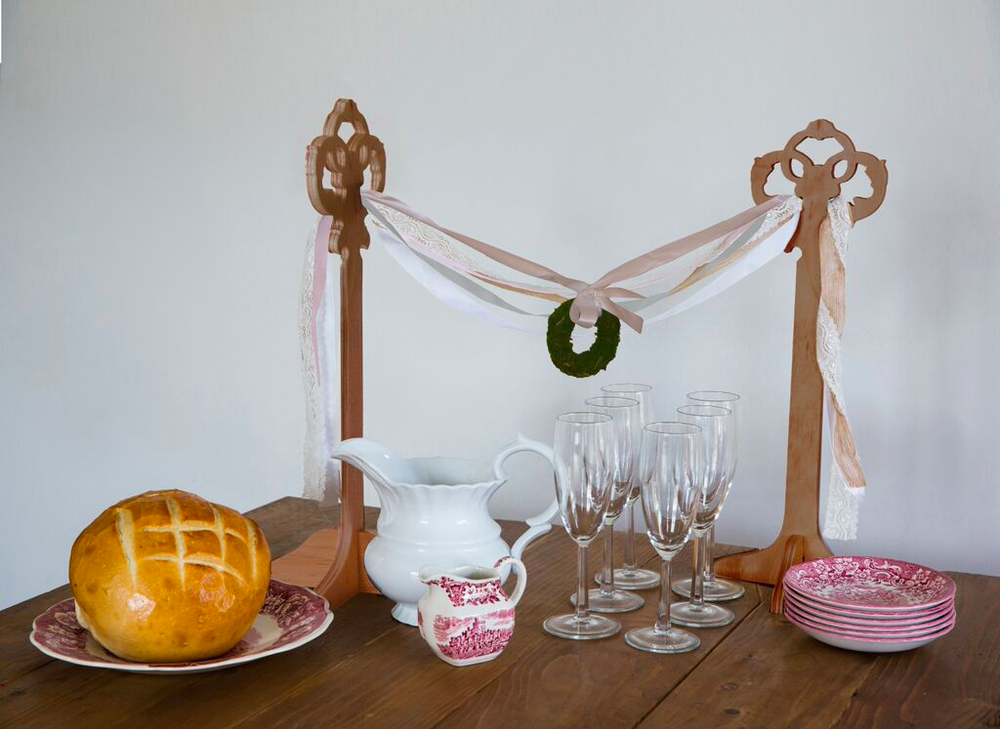 Table Top Garland Stands featuring five colorful ribbon bunting, 18 inches high, available in white and wood finishes.
