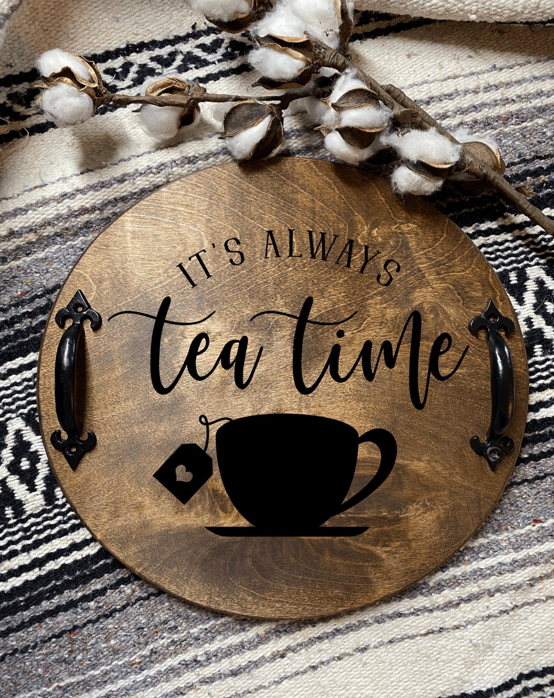 Handmade wood serving tray with black metal handles, stained in dark chestnut color, showcasing unique wood grain patterns.