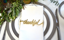 Thankful Wrap Matte Gold napkin wraps elegantly encircling napkins, showcasing a chic matte gold finish for stylish dining decor.