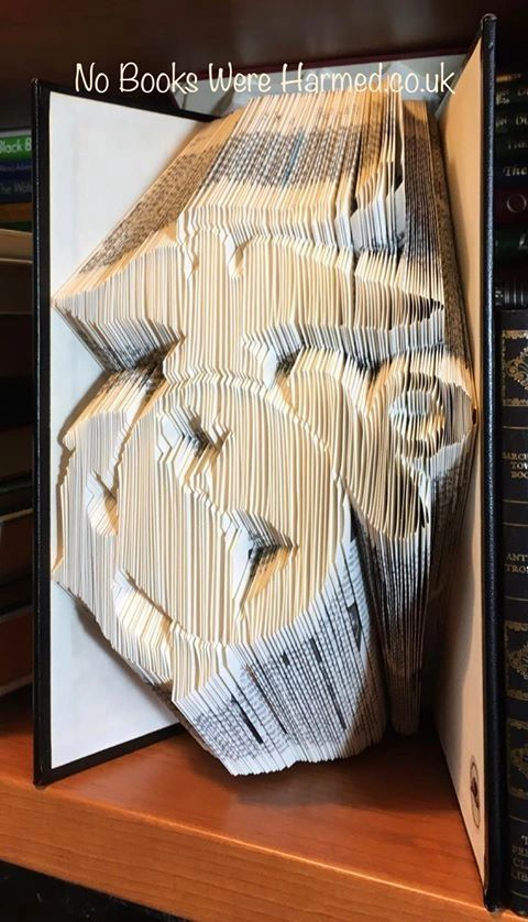 Handcrafted book sculpture of the Marine Corps made from an Encyclopedia Britannica, featuring 1,500 intricate folds.
