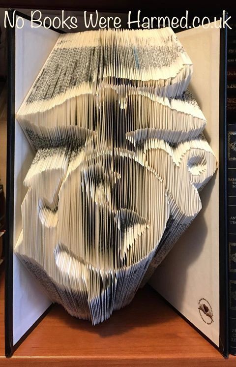 Handcrafted book sculpture of the Marine Corps made from an Encyclopedia Britannica, featuring 1,500 intricate folds.