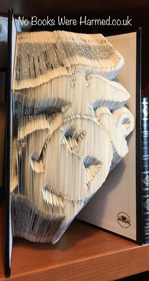 Handcrafted book sculpture of the Marine Corps made from an Encyclopedia Britannica, featuring 1,500 intricate folds.