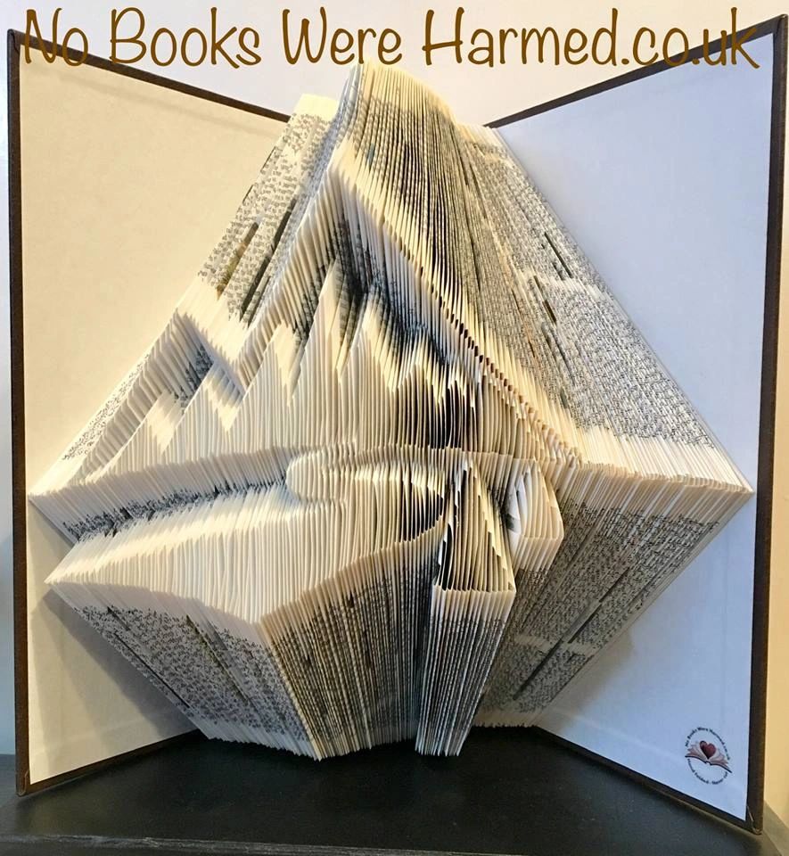 Handcrafted book art titled 'The Mountains Are Calling', made from vintage Encyclopaedia Britannica pages, showcasing intricate folds and unique design.