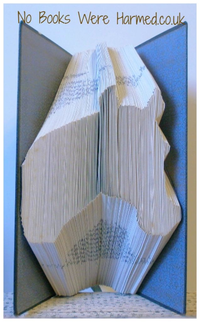 Handcrafted book art sculpture of a horse's head made from vintage books, showcasing intricate page folding techniques.