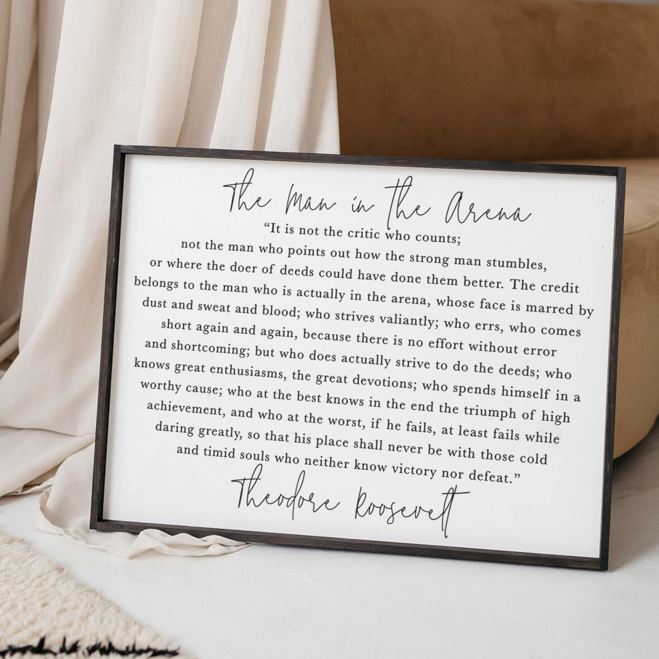 The Man In The Arena Wood Sign featuring a waterproof design, stained pine wood frame, and textured background, measuring 25x19 inches.