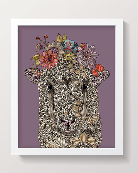 Artwork of a sheep surrounded by colorful flowers on photographic paper.