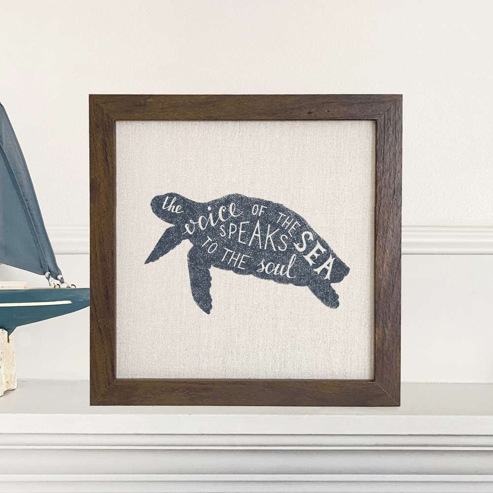 Framed sign featuring 'The Voice of the Sea' design with a natural wood frame and linen-look background.