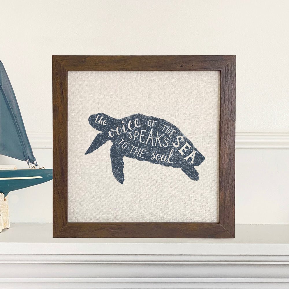 Framed sign featuring 'The Voice of the Sea' design with a natural wood frame and linen-look background.